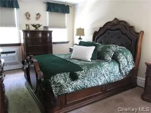 Bedroom with carpet flooring and cooling unit Bedroom with carpet flooring and cooling unit