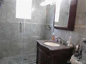 Bathroom featuring vanity and a shower stall Bathroom featuring vanity and a shower stall