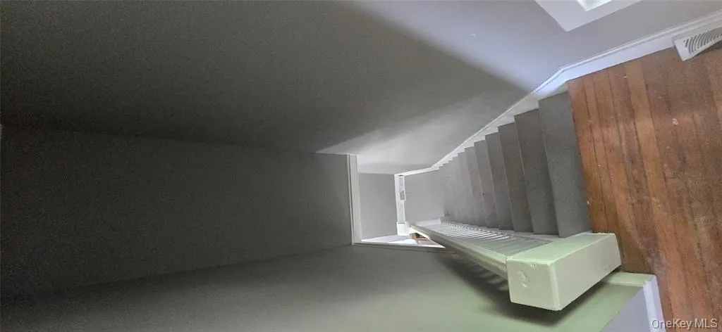 Staircase with visible vents, baseboards, and wood finished floors Staircase with visible vents, baseboards, and wood finished floors