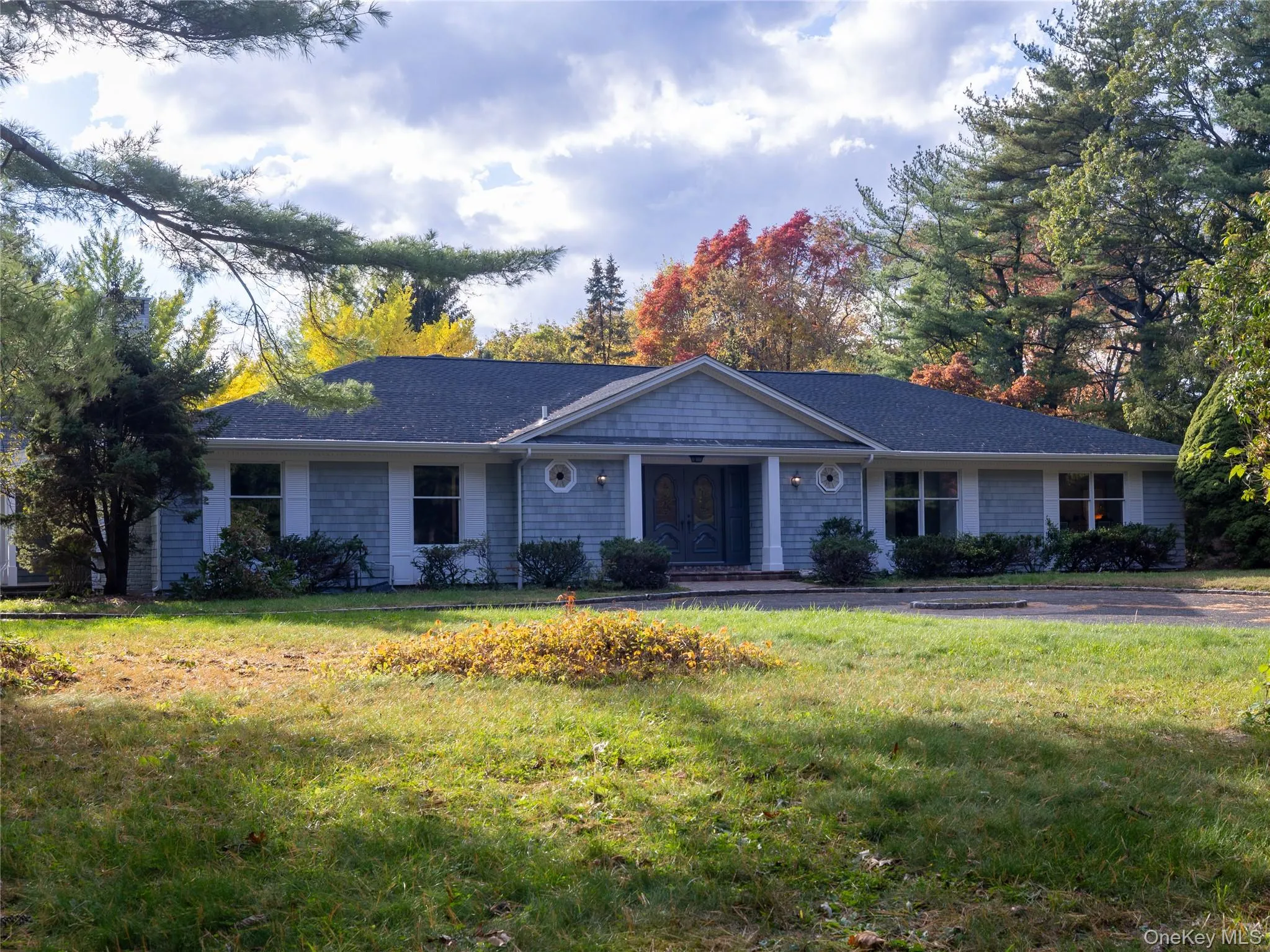 Single story home with a front lawn and a porch Single story home with a front lawn and a porch