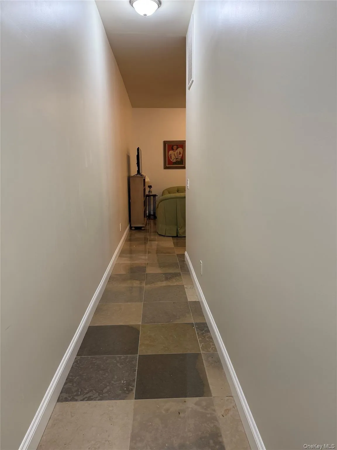 Long Hallway into apartment with stone tiles and high ceilig Long Hallway into apartment with stone tiles and high ceilig