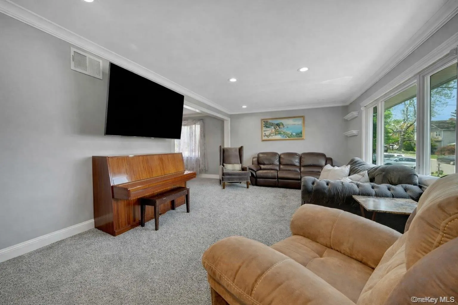 A close up of the bright and sun filled living room showing its recessed lighting A close up of the bright and sun filled living room showing its recessed lighting
