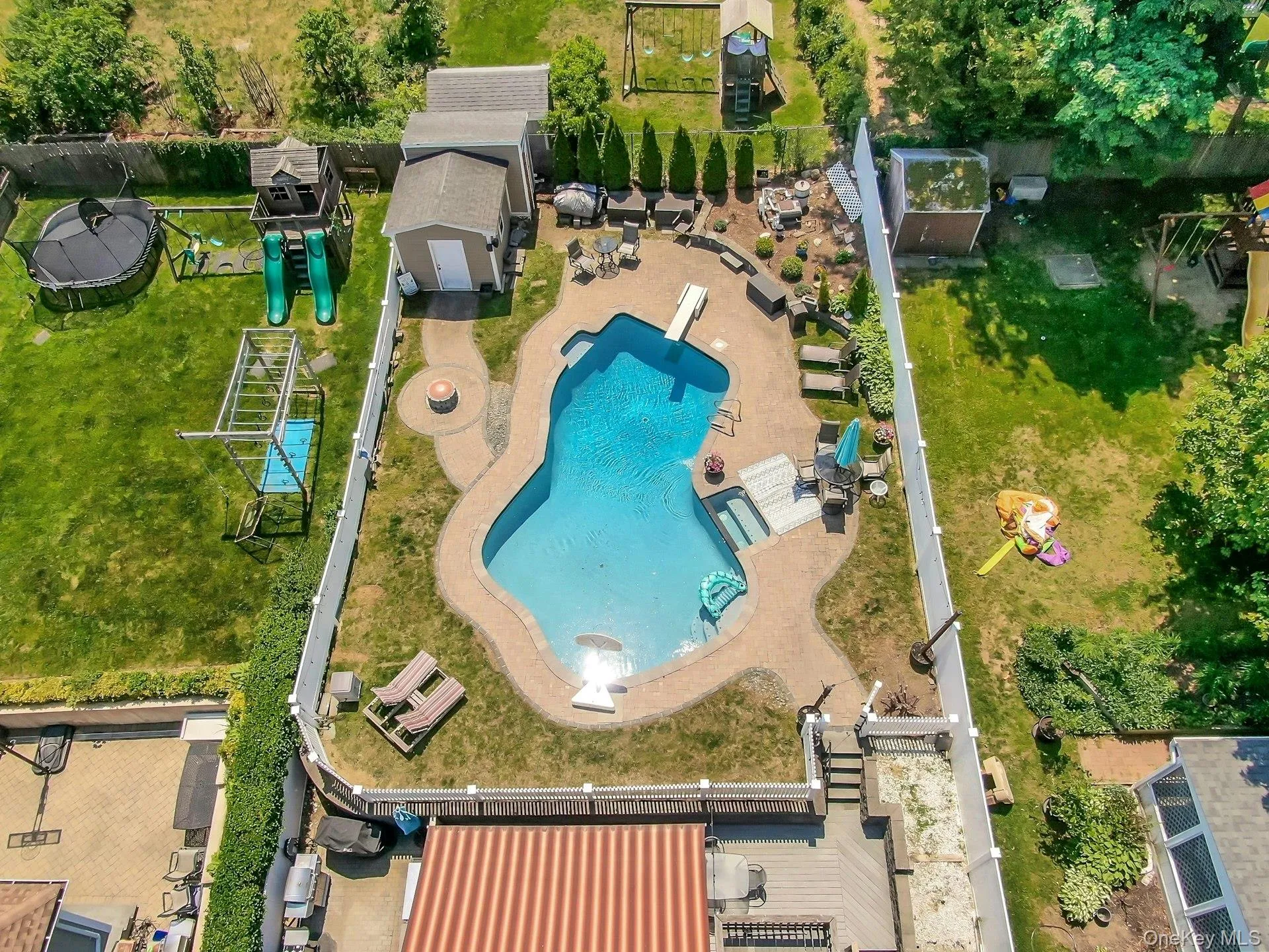 Another aerial view of the yard and pool Another aerial view of the yard and pool