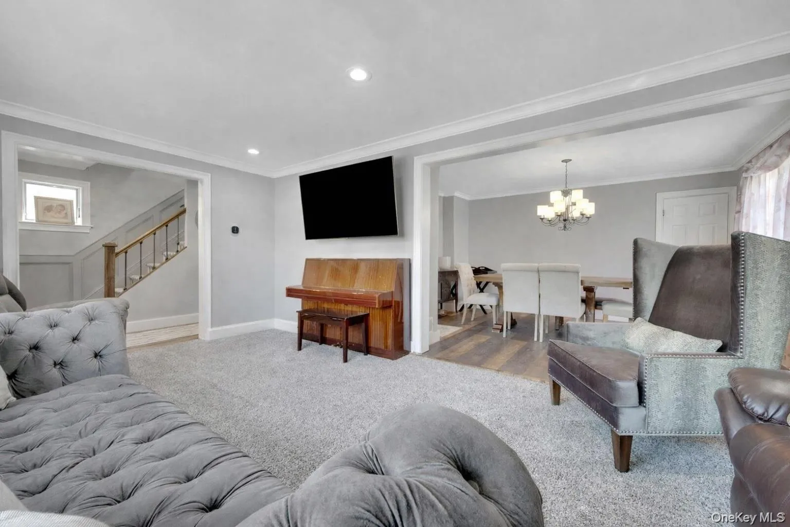 As we enter the home, you are greeted with a large living room that opens to the dining room As we enter the home, you are greeted with a large living room that opens to the dining room