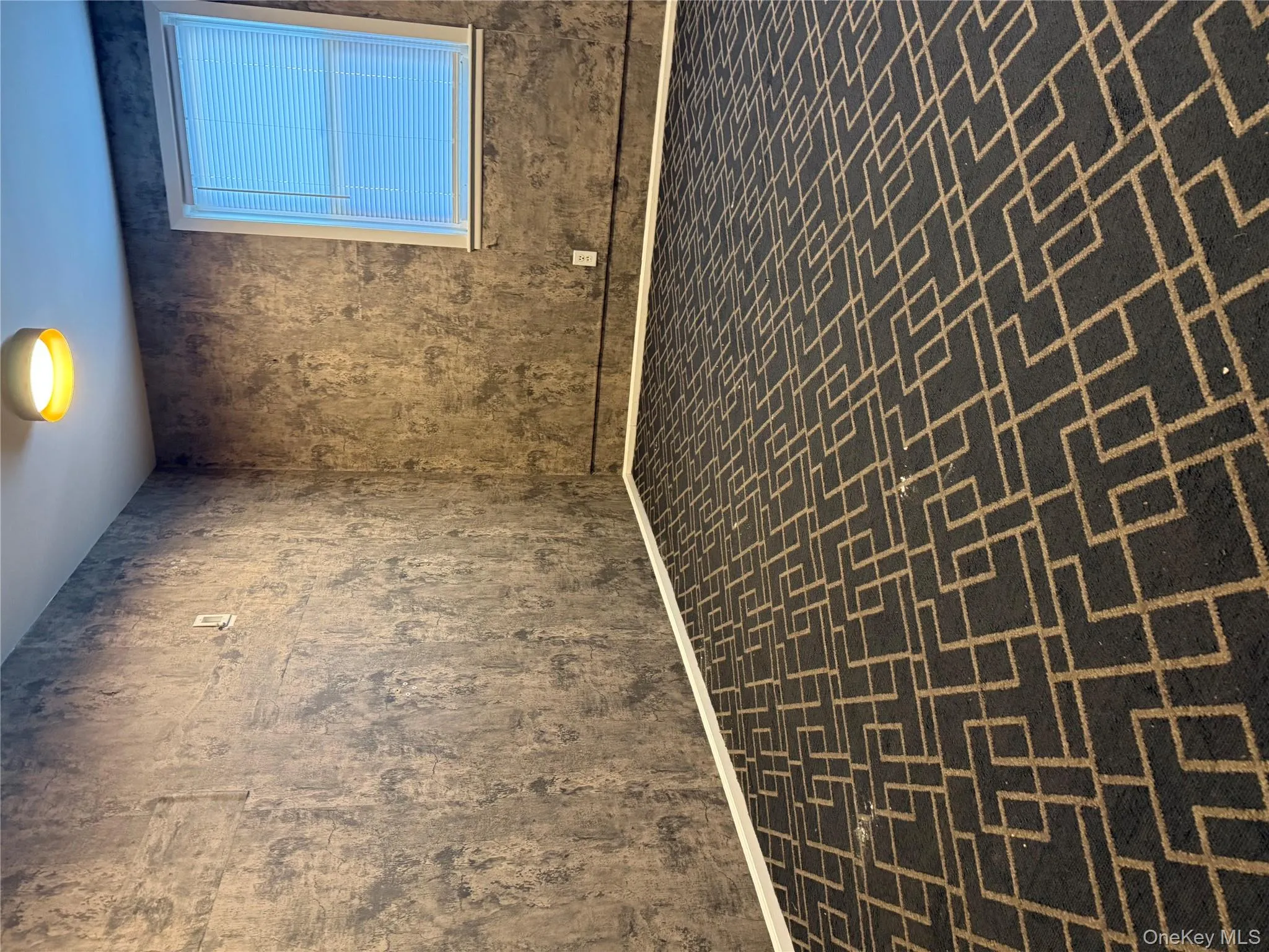 Empty room featuring brick floors and baseboards Empty room featuring brick floors and baseboards