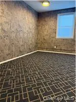 Spare room with brick flooring and baseboards Spare room with brick flooring and baseboards