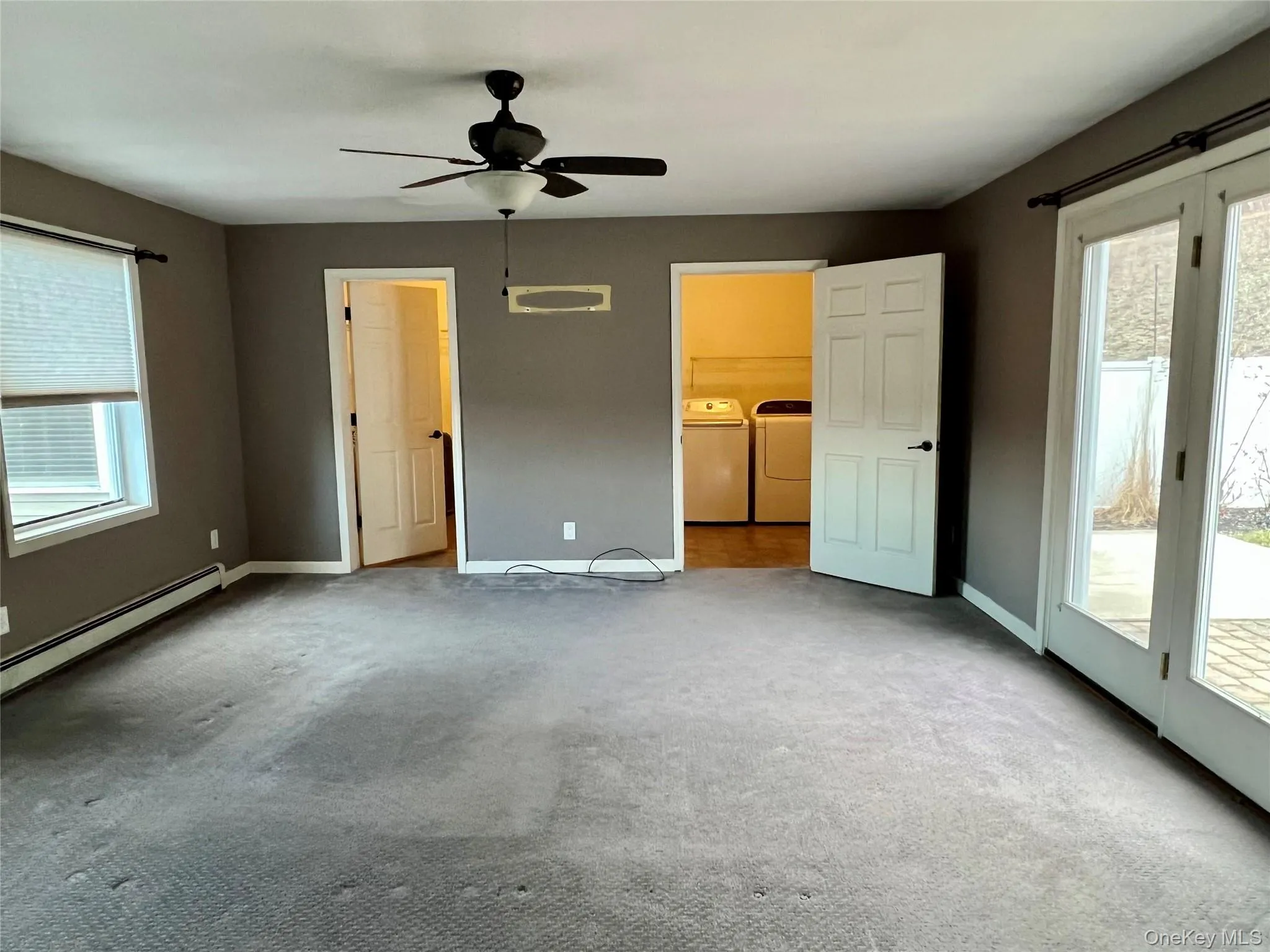 Unfurnished bedroom with multiple windows, access to outside, ceiling fan, and carpet Unfurnished bedroom with multiple windows, access to outside, ceiling fan, and carpet