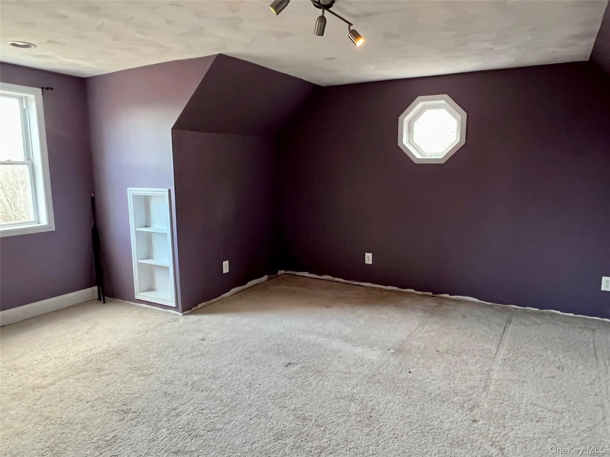 Additional living space featuring vaulted ceiling and carpet floors Additional living space featuring vaulted ceiling and carpet floors