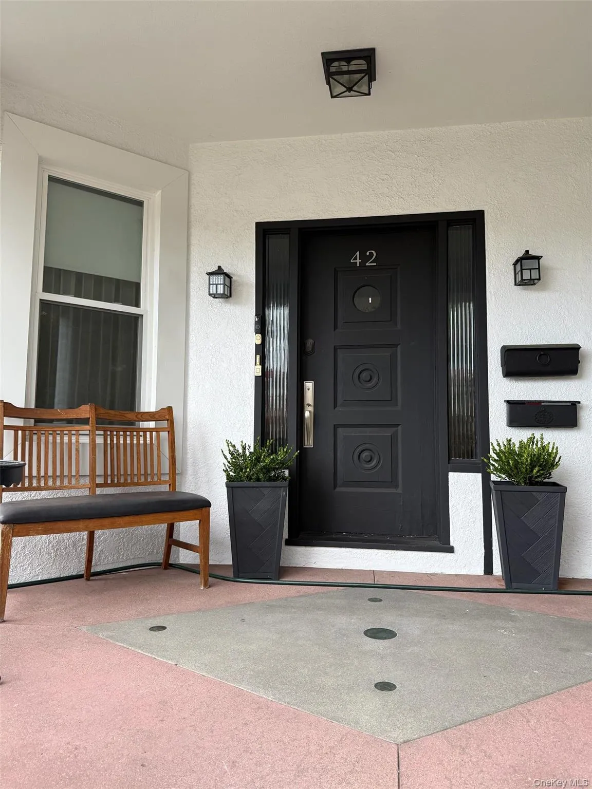 Entrance to property featuring stucco siding Entrance to property featuring stucco siding
