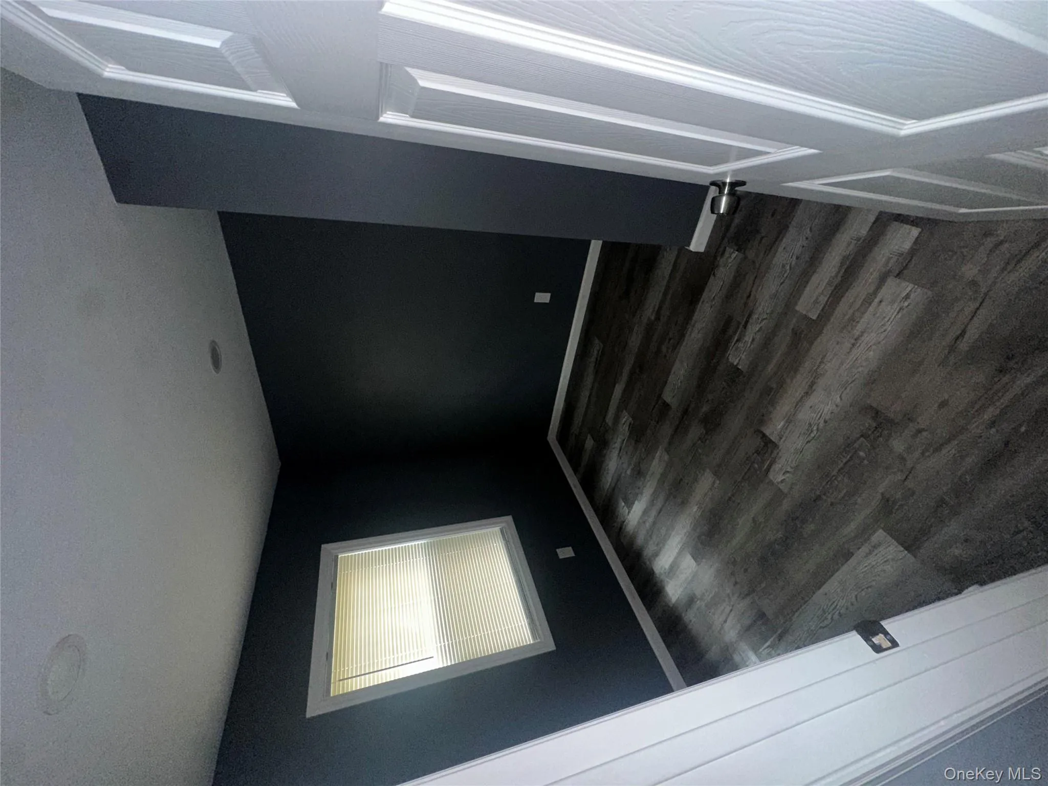 Spare room with dark wood-style flooring and baseboards Spare room with dark wood-style flooring and baseboards