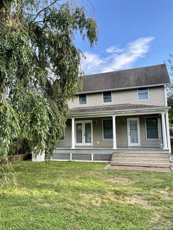 View of front of house with covered porch and a front lawn View of front of house with covered porch and a front lawn