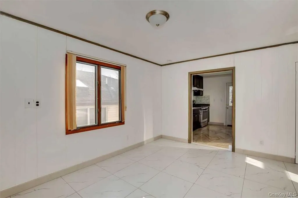Empty room with light marble finish floors and crown molding Empty room with light marble finish floors and crown molding