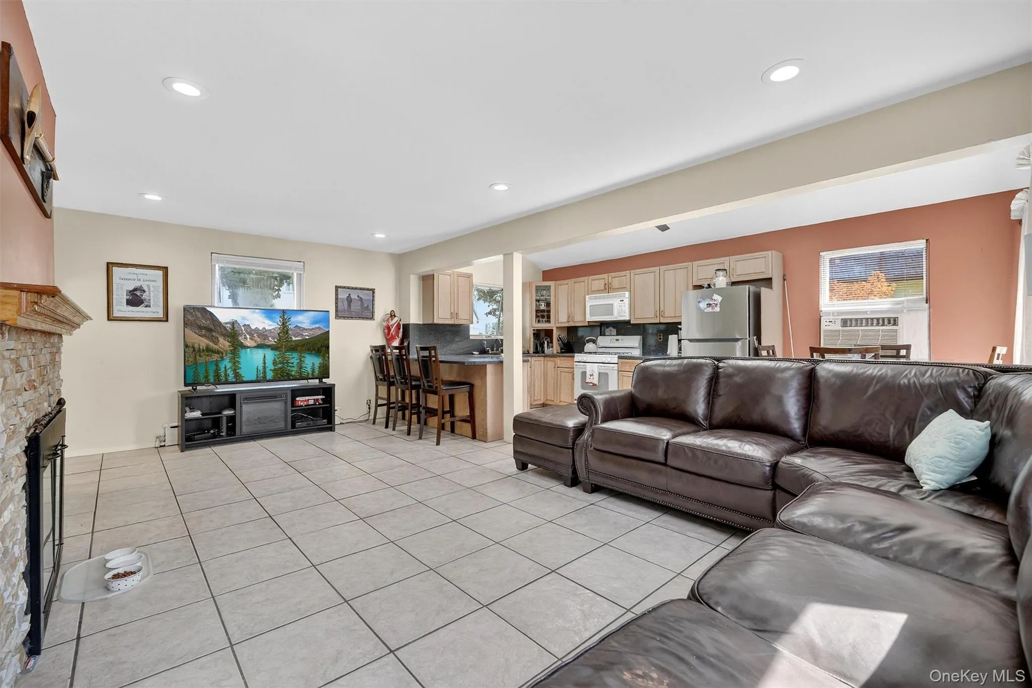 Living area with light tile patterned floors, a fireplace, and recessed lighting Living area with light tile patterned floors, a fireplace, and recessed lighting