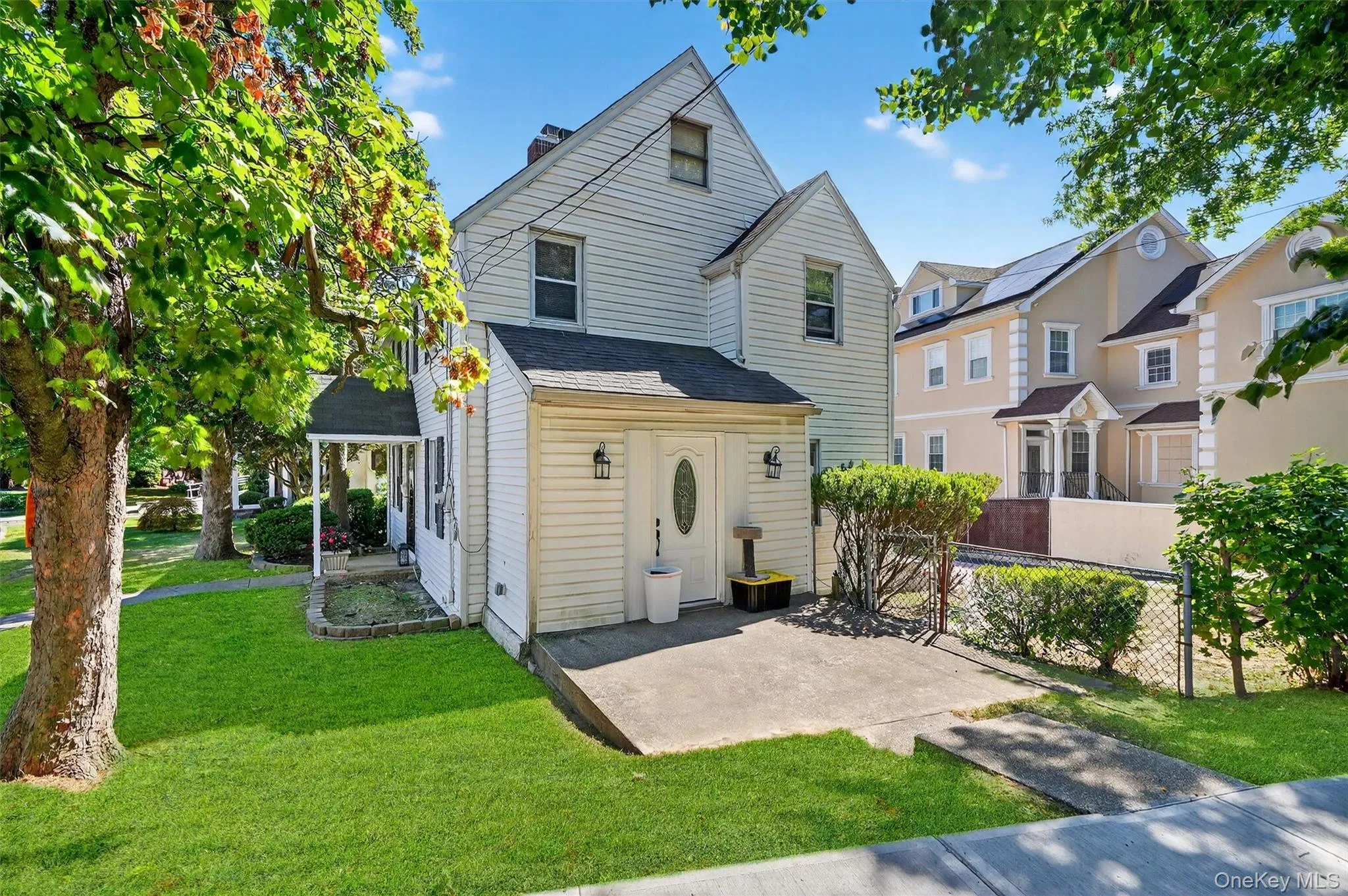 Traditional home with roof with shingles, a front lawn, and a chimney Traditional home with roof with shingles, a front lawn, and a chimney