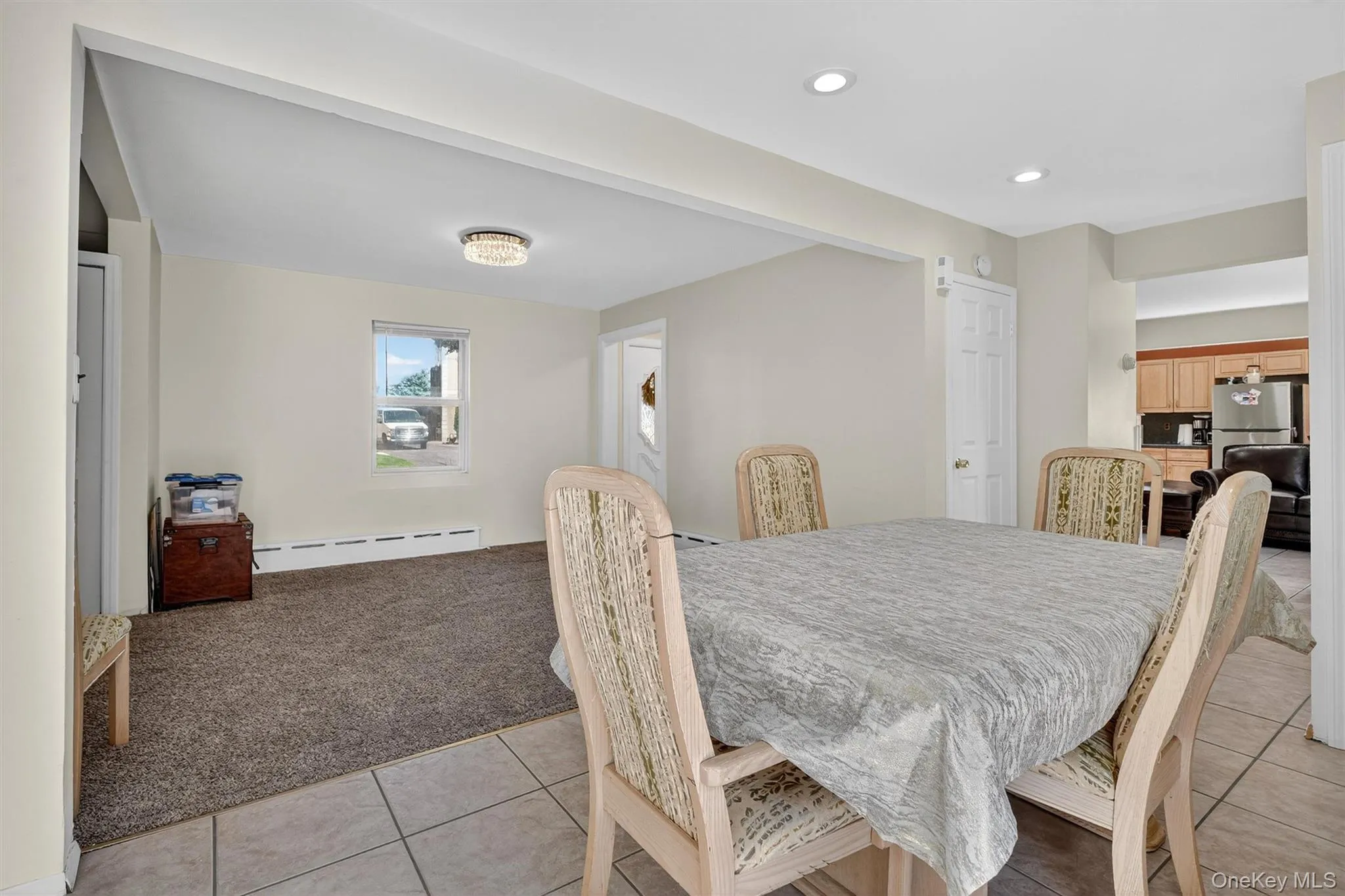 Dining space featuring light colored carpet, a baseboard heating unit, light tile patterned floors, and recessed lighting Dining space featuring light colored carpet, a baseboard heating unit, light tile patterned floors, and recessed lighting