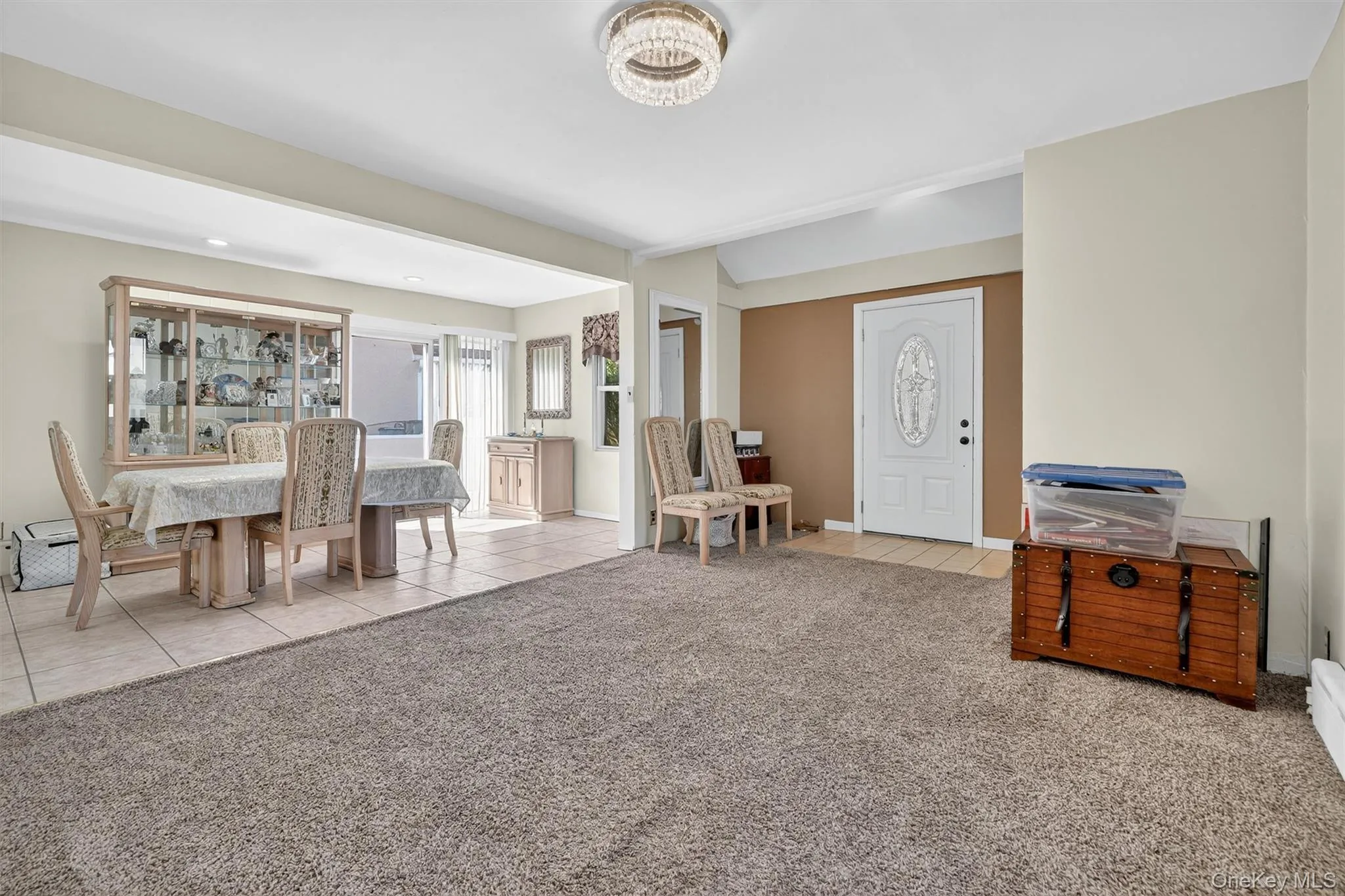 Foyer featuring light tile patterned flooring and light colored carpet Foyer featuring light tile patterned flooring and light colored carpet
