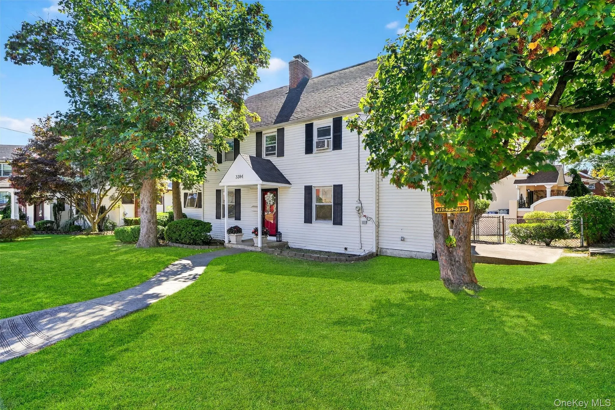 Colonial-style house with a chimney and roof with shingles Colonial-style house with a chimney and roof with shingles