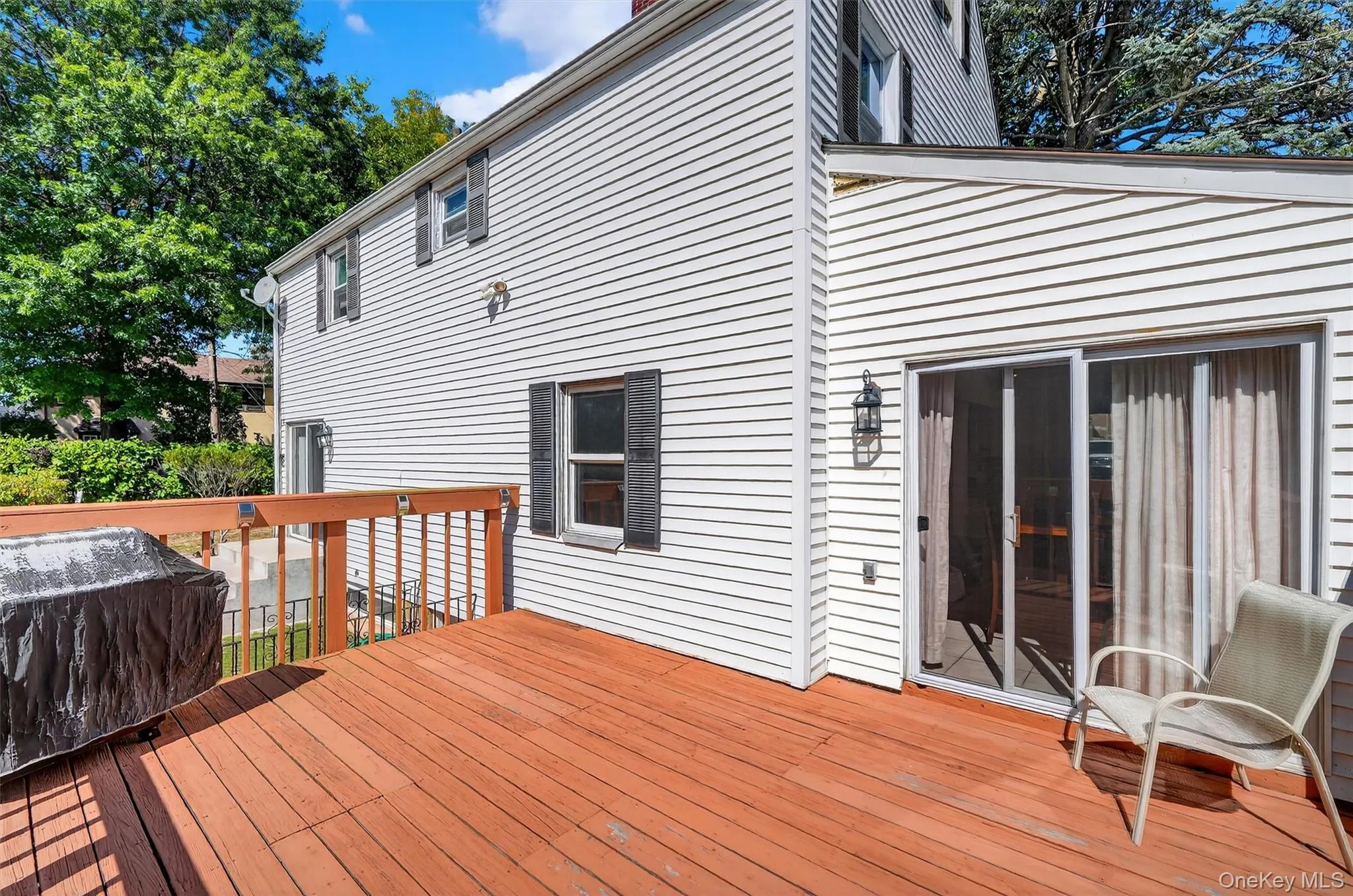 Wooden deck featuring grilling area Wooden deck featuring grilling area