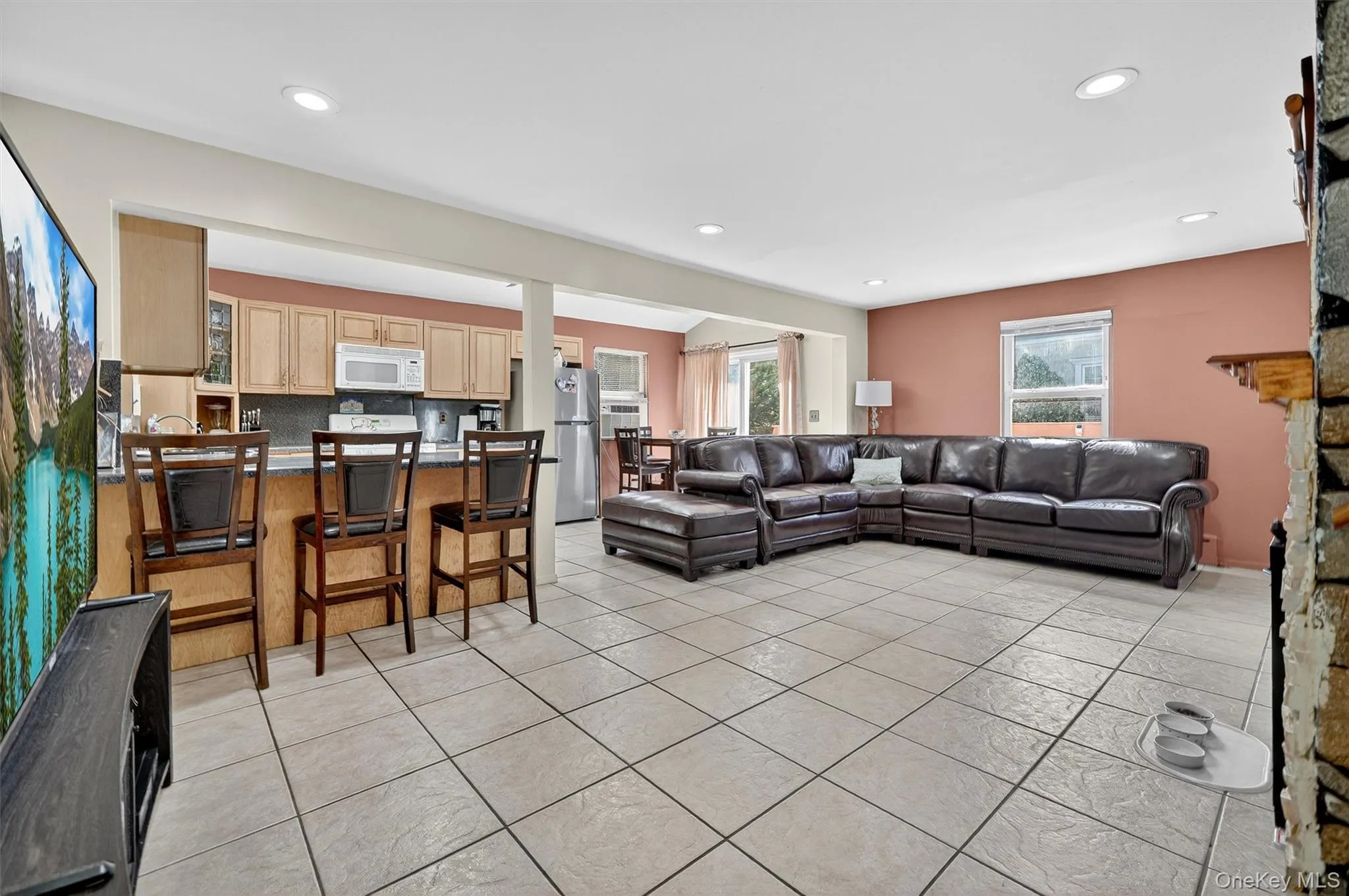 Living area featuring recessed lighting and light tile patterned floors Living area featuring recessed lighting and light tile patterned floors