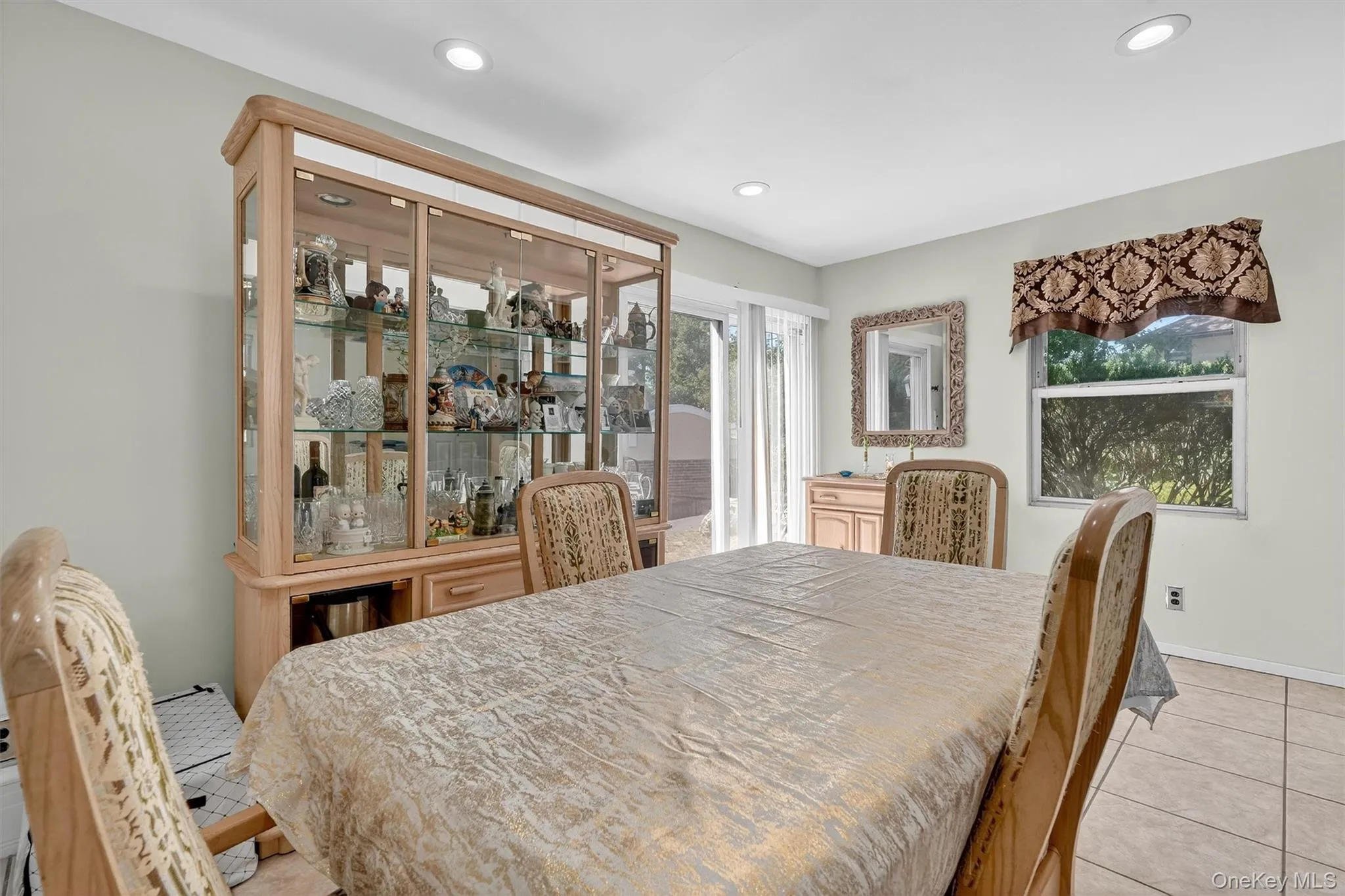 Dining room featuring light tile patterned flooring and recessed lighting Dining room featuring light tile patterned flooring and recessed lighting