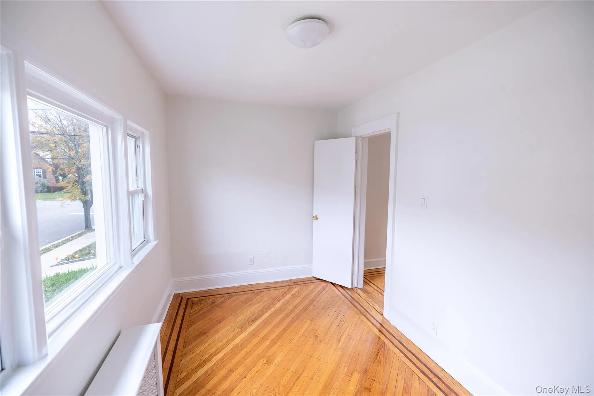 Empty room with wood-type flooring and radiator Empty room with wood-type flooring and radiator