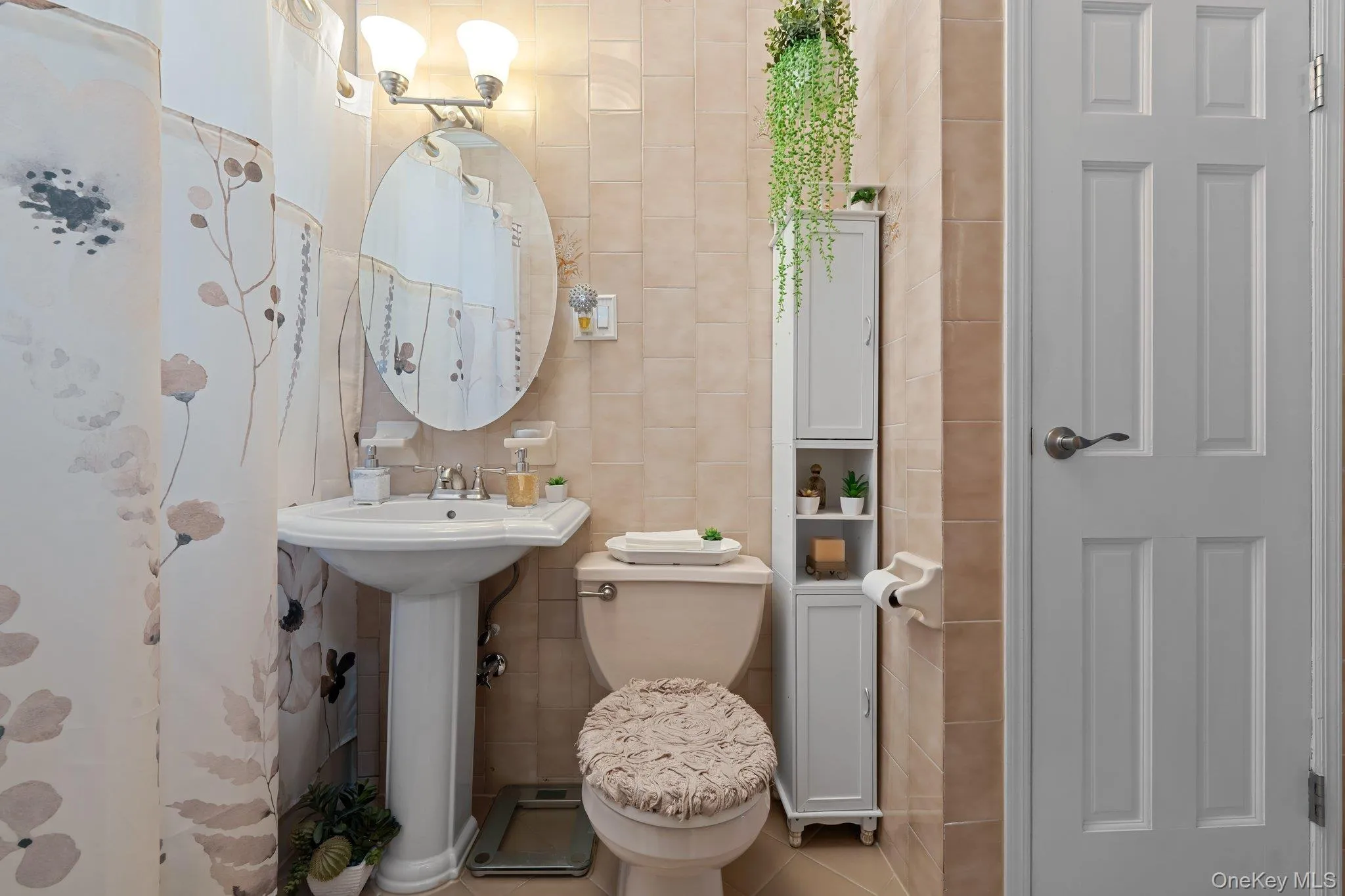 Half bath featuring tile walls and tile patterned flooring Half bath featuring tile walls and tile patterned flooring
