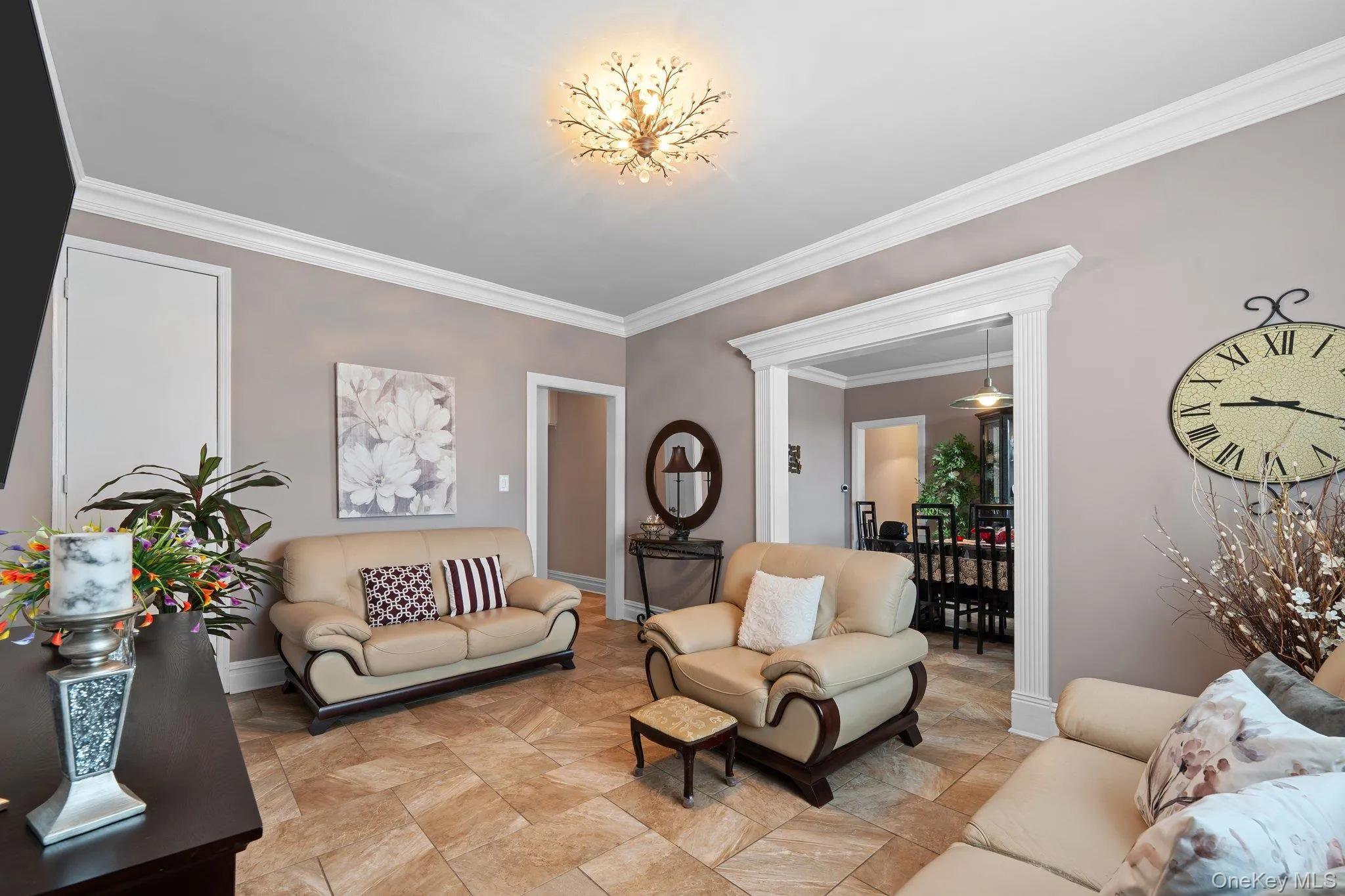 Currently set up as a Living room with ornamental molding and baseboards Currently set up as a Living room with ornamental molding and baseboards