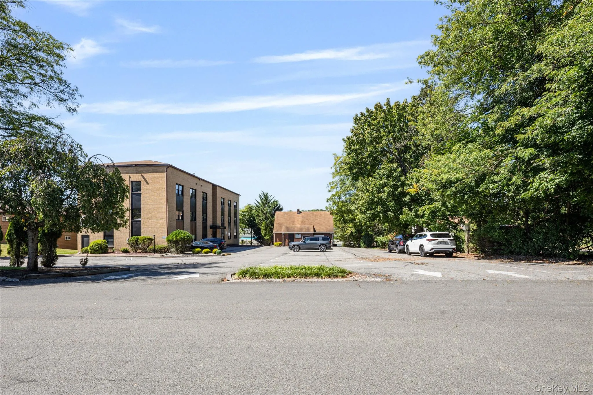 View of property featuring uncovered parking View of property featuring uncovered parking