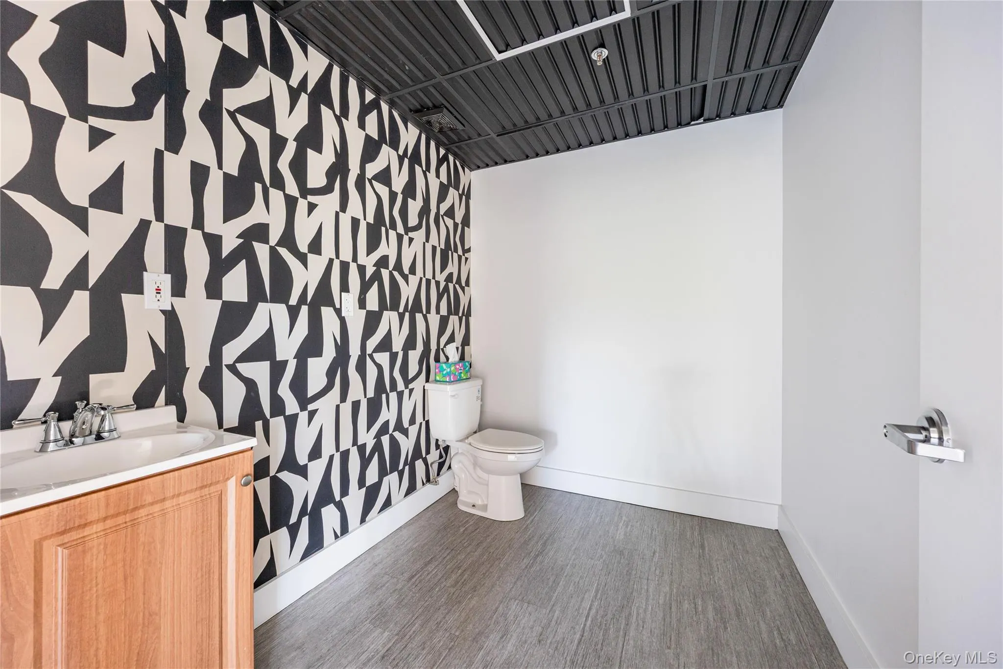 Half bath with vanity and dark wood-style floors Half bath with vanity and dark wood-style floors