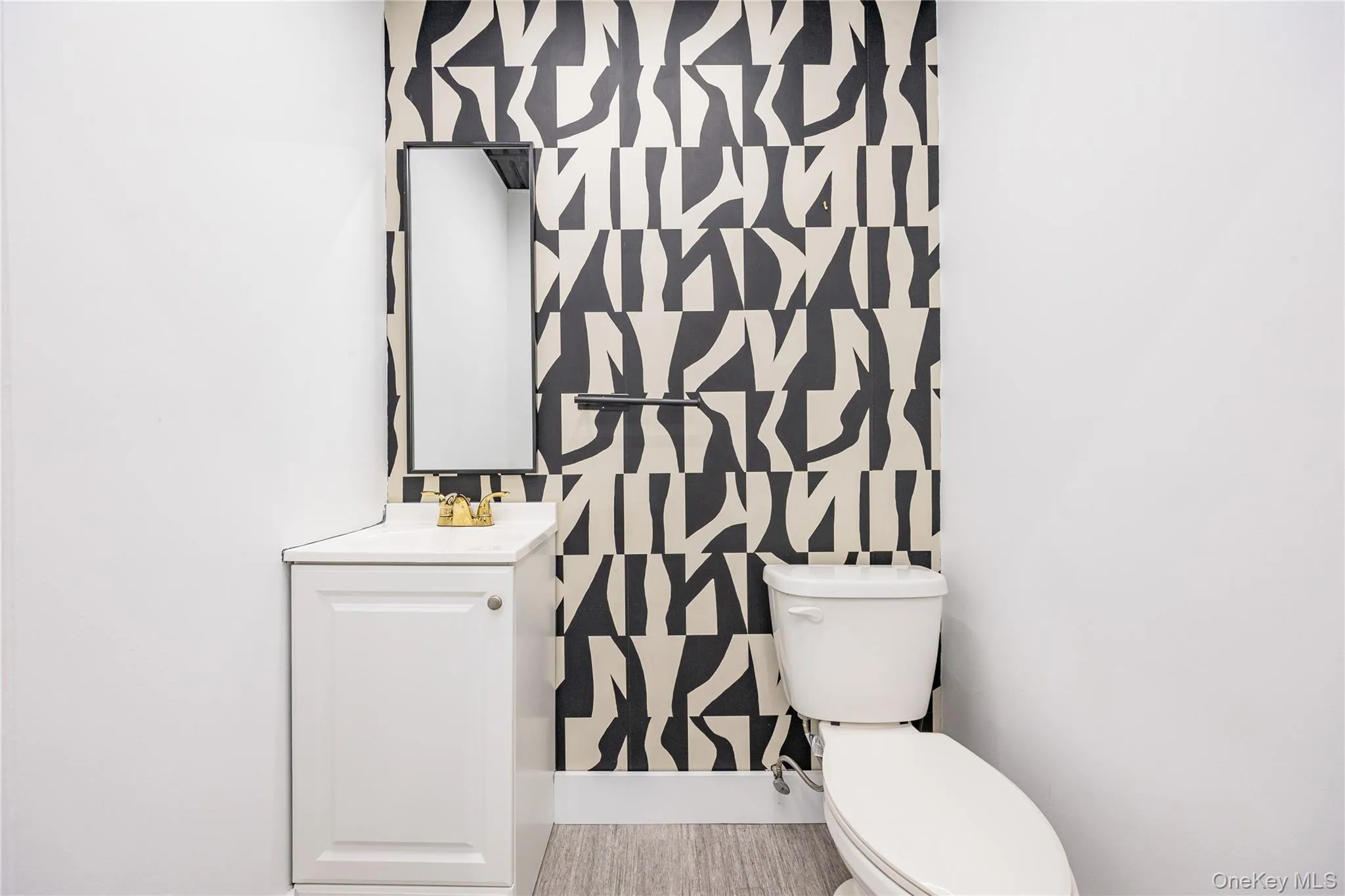 Bathroom featuring vanity and toilet Bathroom featuring vanity and toilet