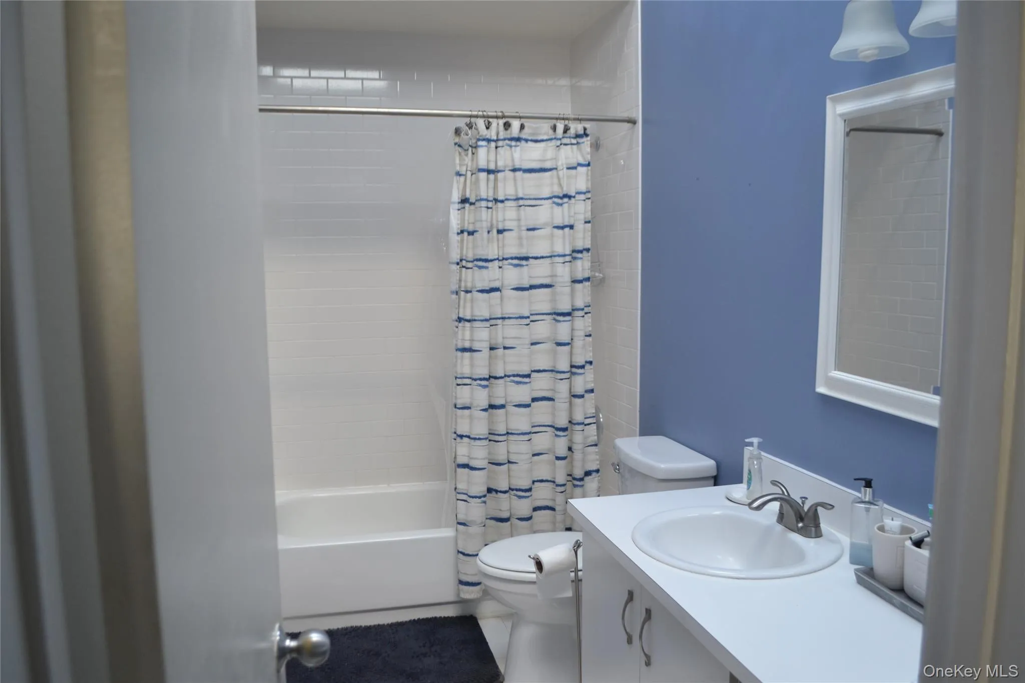 Bathroom with shower / bathtub combination with curtain and vanity Bathroom with shower / bathtub combination with curtain and vanity