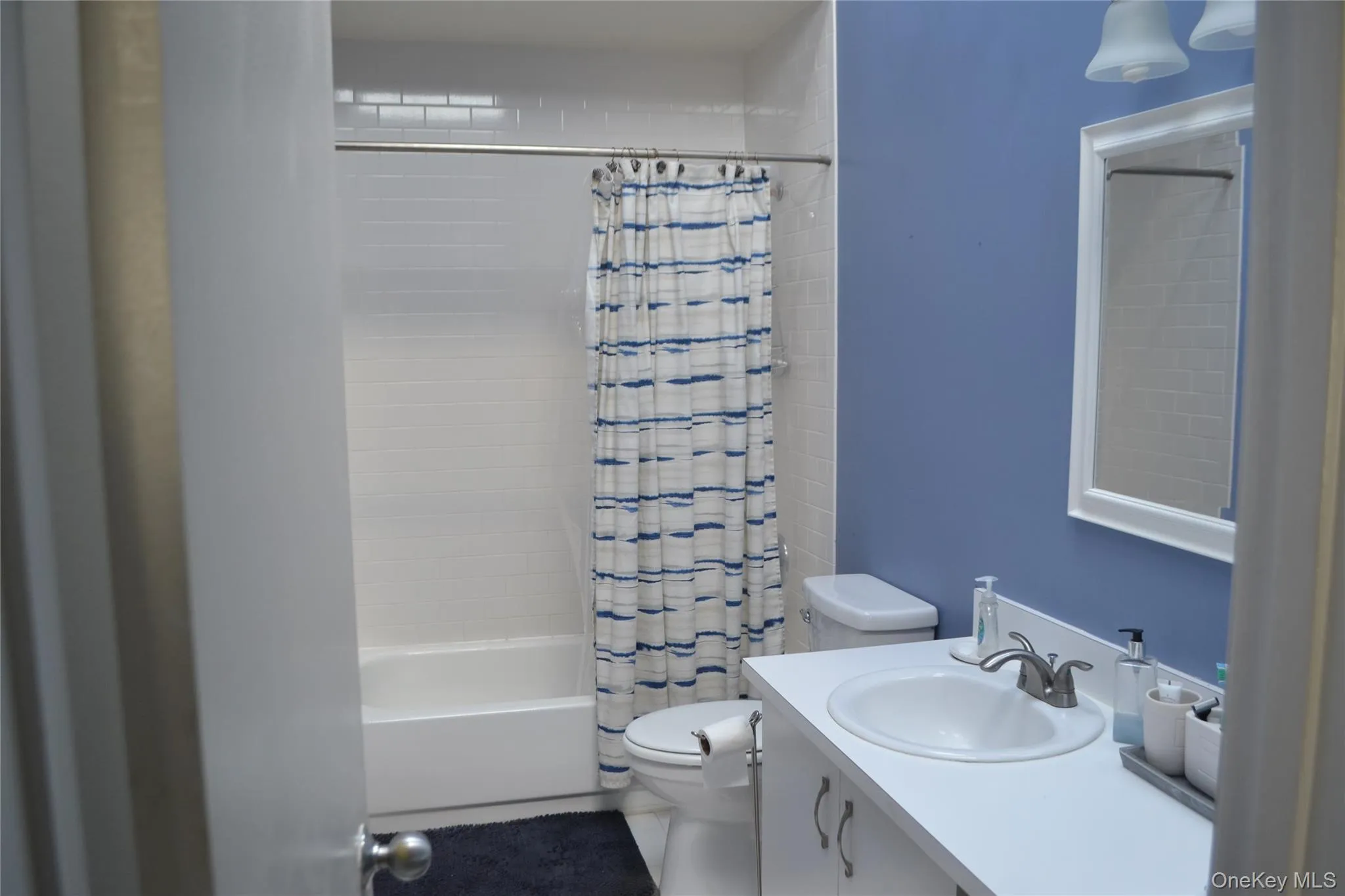 Bathroom with shower / bathtub combination with curtain and vanity Bathroom with shower / bathtub combination with curtain and vanity