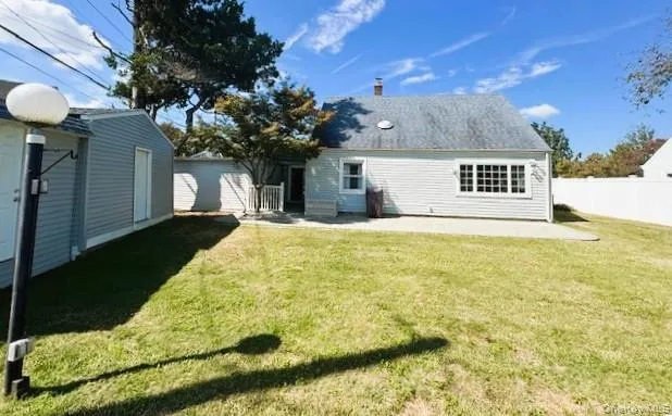 Rear view of property with a patio and a yard Rear view of property with a patio and a yard