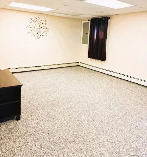 Spare room featuring a paneled ceiling and a baseboard radiator Spare room featuring a paneled ceiling and a baseboard radiator