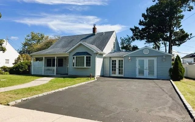 Rear view of property with french doors, a yard, a porch, a chimney, and a shingled roof Rear view of property with french doors, a yard, a porch, a chimney, and a shingled roof