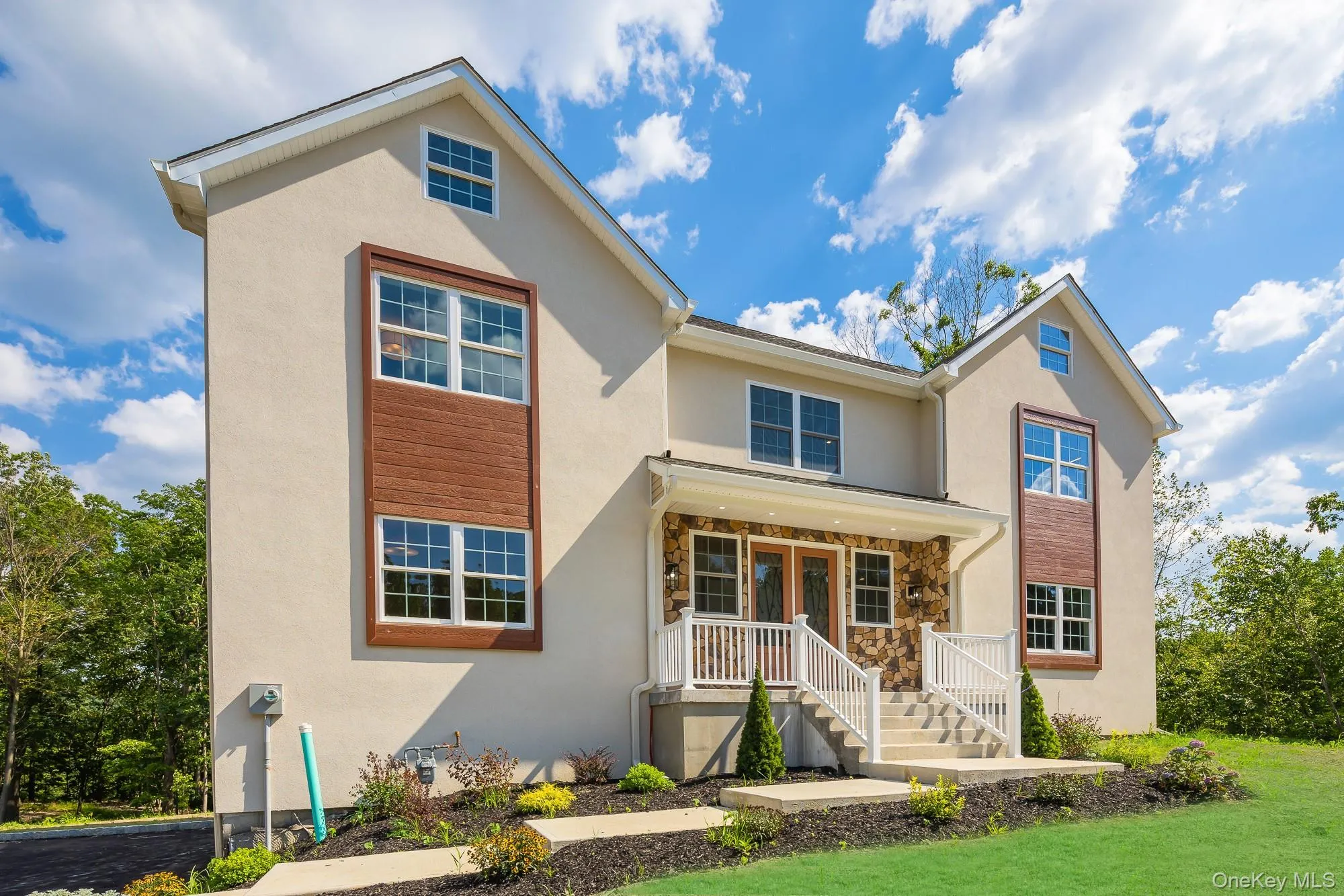 Traditional home with a front yard and stucco siding Traditional home with a front yard and stucco siding