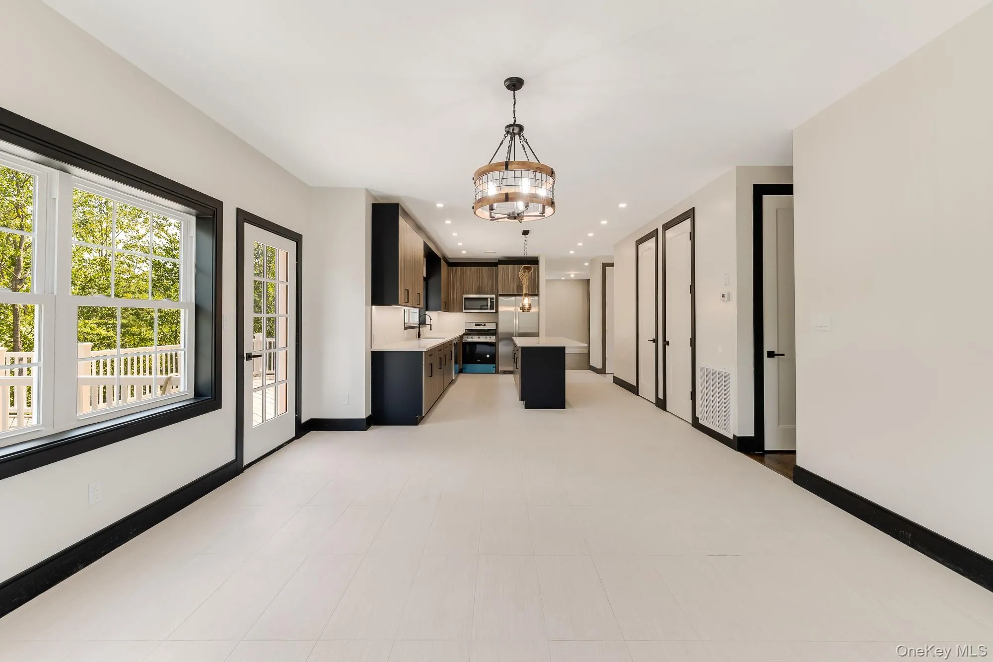 Kitchen featuring an inviting chandelier, light countertops, appliances with stainless steel finishes, and a sink Kitchen featuring an inviting chandelier, light countertops, appliances with stainless steel finishes, and a sink