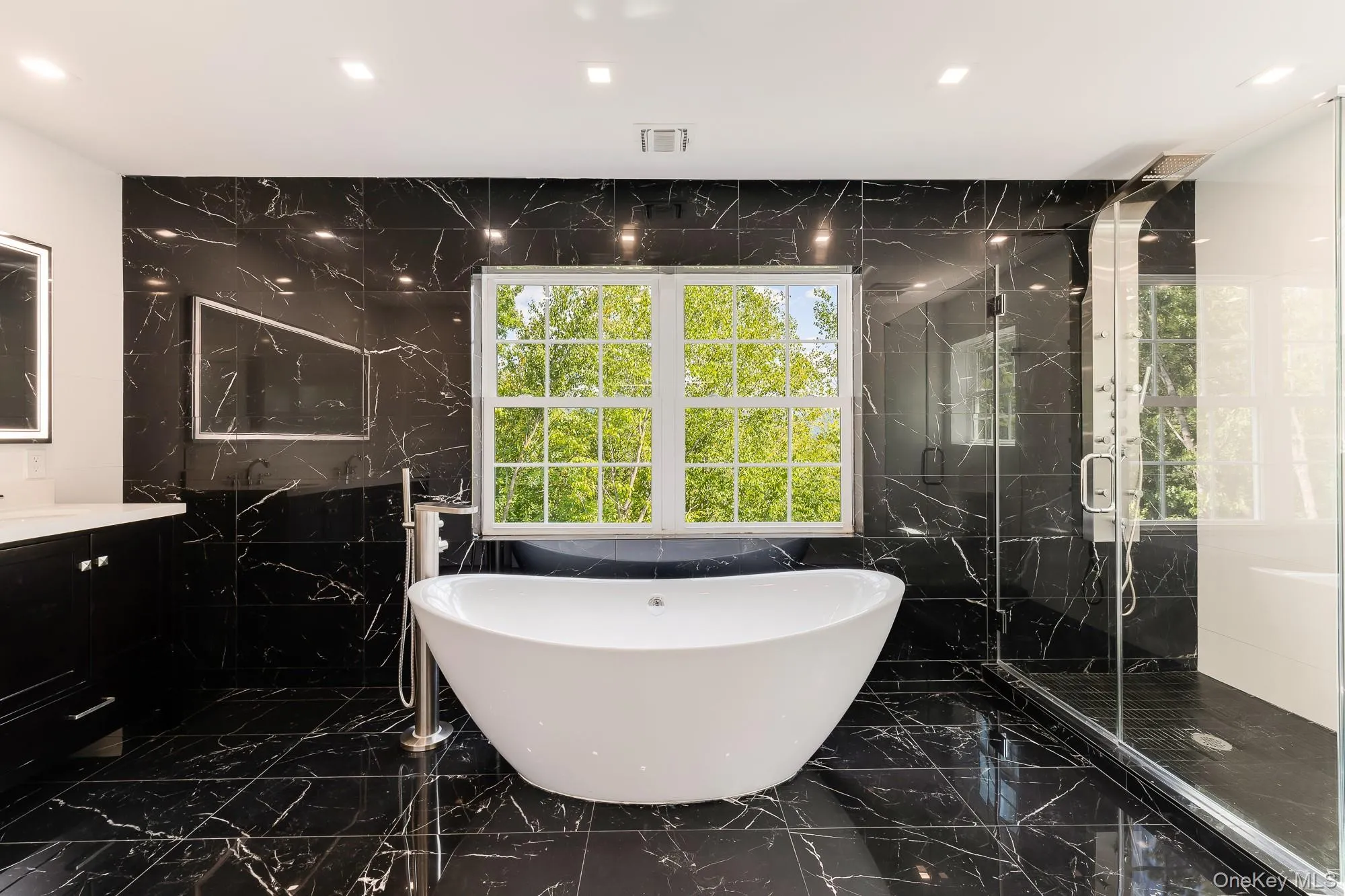 Full bath with a marble finish shower, visible vents, marble finish floor, and vanity Full bath with a marble finish shower, visible vents, marble finish floor, and vanity