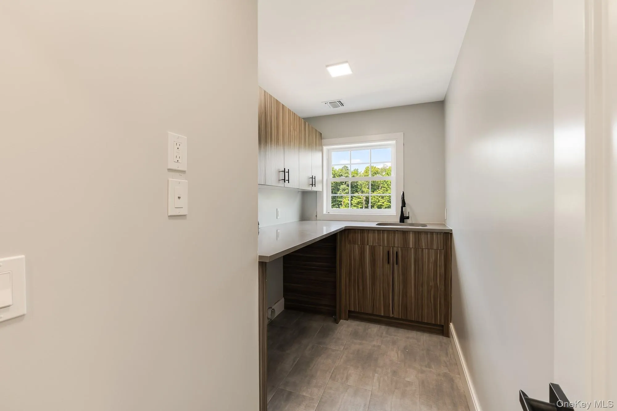 Kitchen with light countertops, a sink, and visible vents Kitchen with light countertops, a sink, and visible vents