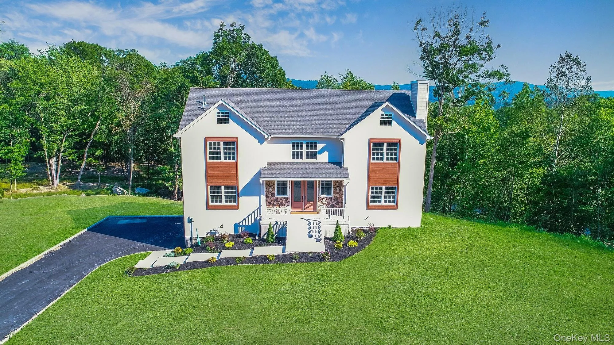 View of front of house with a chimney, stucco siding, stone siding, and a front lawn View of front of house with a chimney, stucco siding, stone siding, and a front lawn