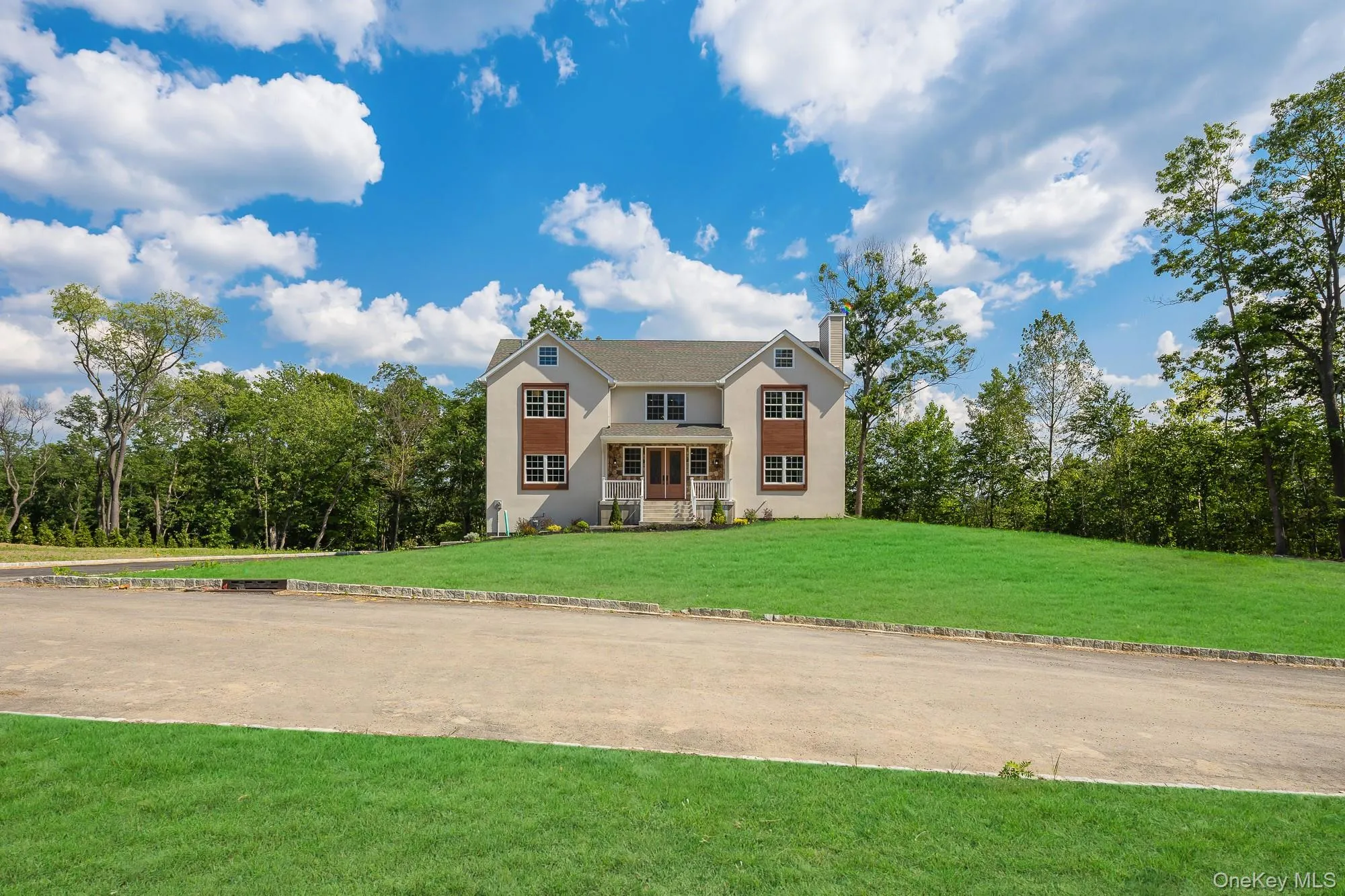 View of front of home with a chimney, stucco siding, and a front lawn View of front of home with a chimney, stucco siding, and a front lawn