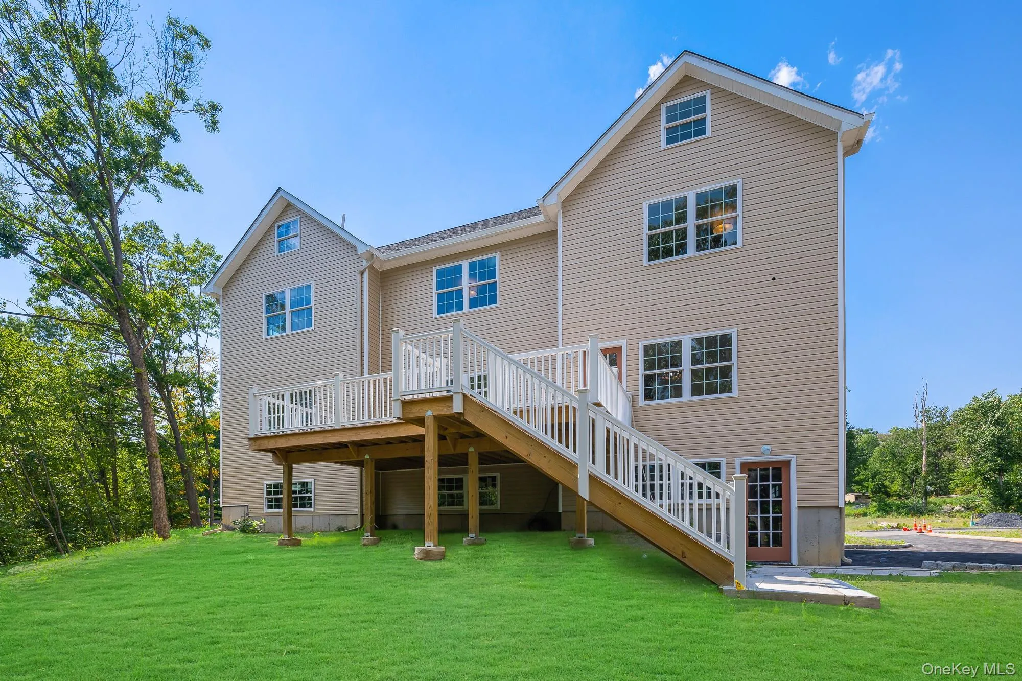 Back of house with a yard, stairway, and a wooden deck Back of house with a yard, stairway, and a wooden deck