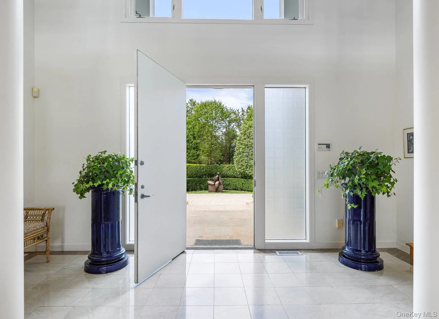 Entrance foyer featuring light tile patterned floors and a towering ceiling Entrance foyer featuring light tile patterned floors and a towering ceiling