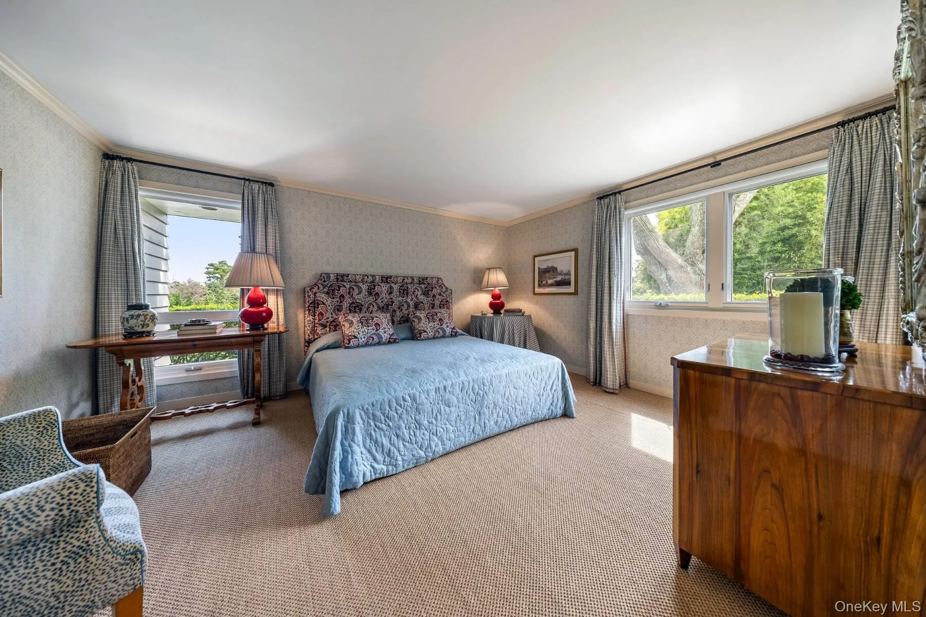 Bedroom featuring ornamental molding, wallpapered walls, and carpet flooring Bedroom featuring ornamental molding, wallpapered walls, and carpet flooring