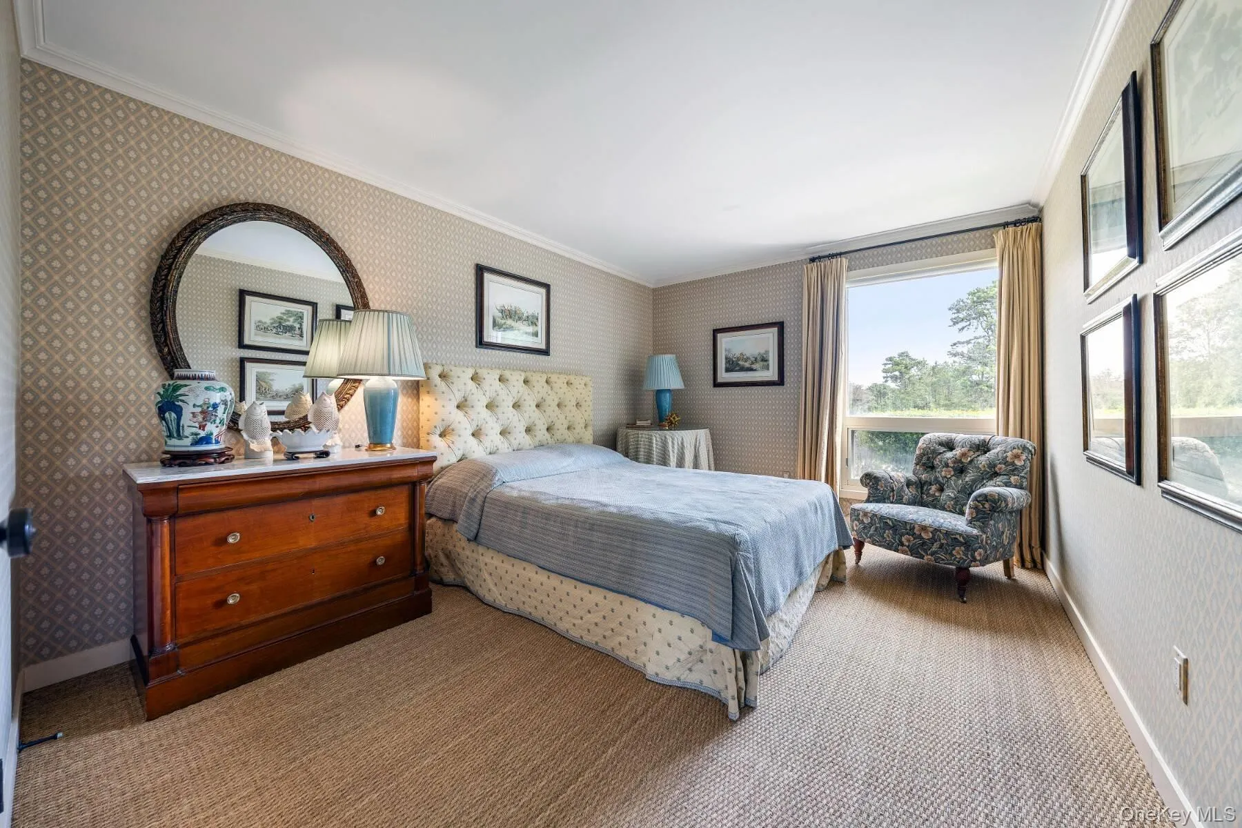 Bedroom with wallpapered walls, ornamental molding, and carpet floors Bedroom with wallpapered walls, ornamental molding, and carpet floors