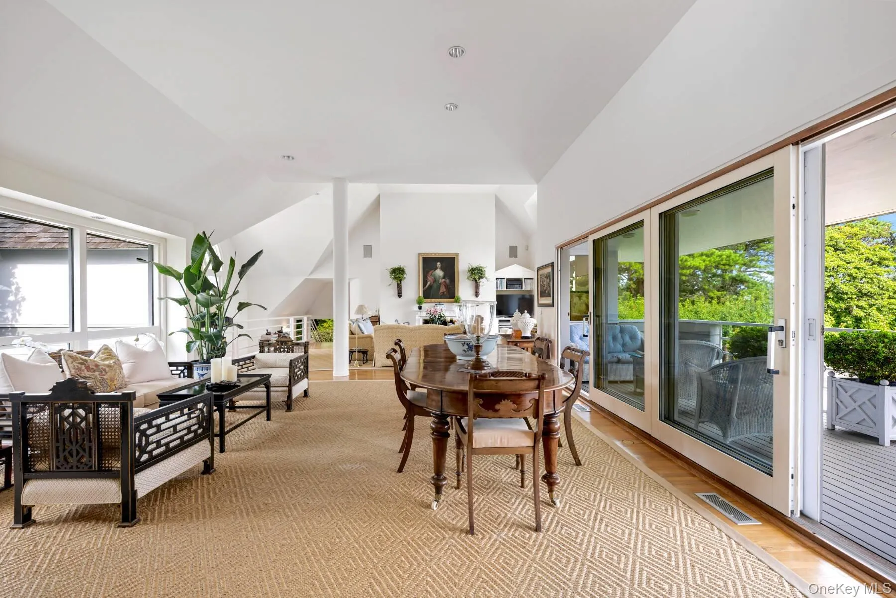 Dining area featuring light wood-style floors and high vaulted ceiling Dining area featuring light wood-style floors and high vaulted ceiling