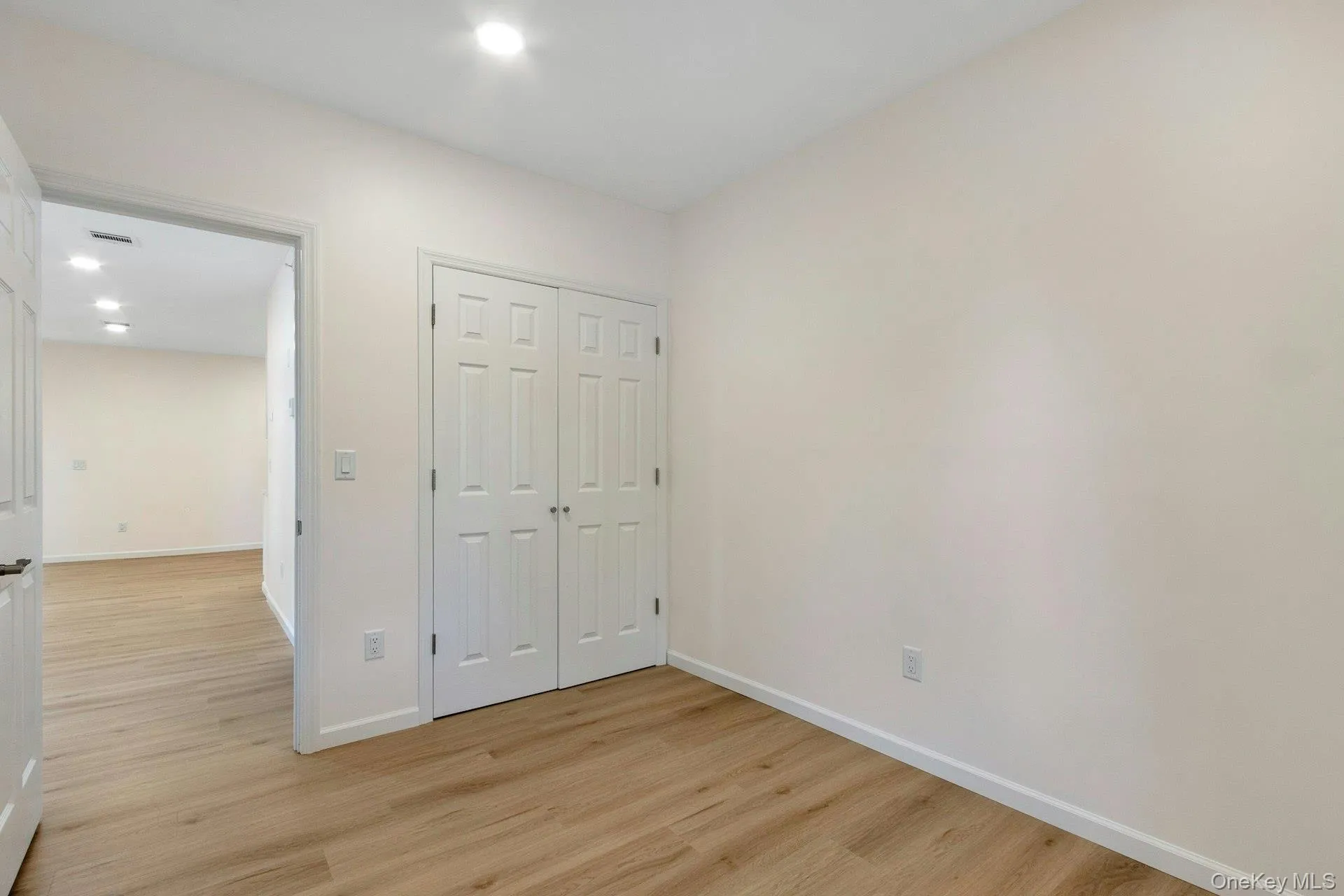 Unfurnished bedroom with light wood-style flooring, recessed lighting, and a closet Unfurnished bedroom with light wood-style flooring, recessed lighting, and a closet