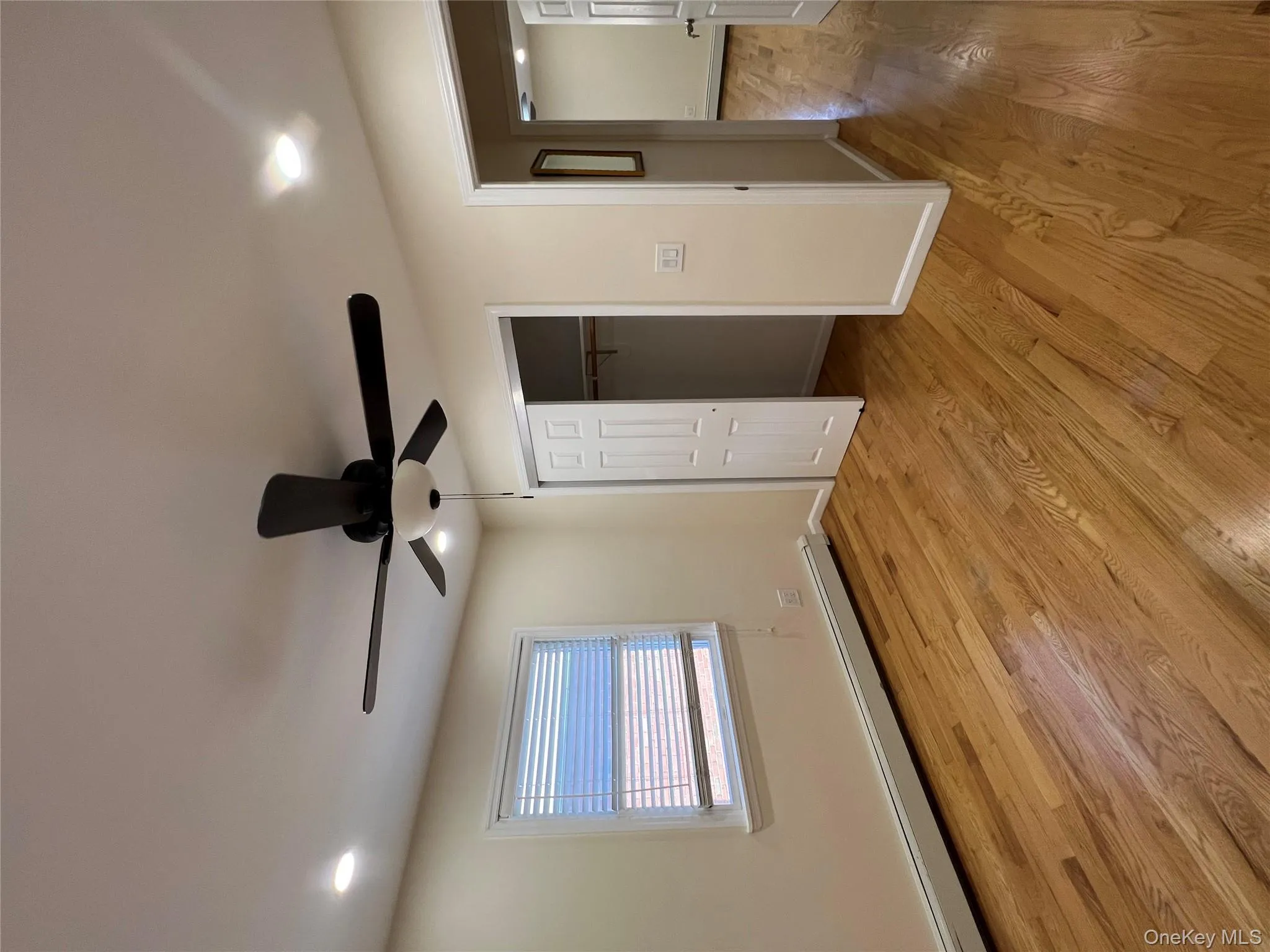 Unfurnished bedroom featuring baseboard heating, light wood-style floors, ceiling fan, a closet, and recessed lighting Unfurnished bedroom featuring baseboard heating, light wood-style floors, ceiling fan, a closet, and recessed lighting