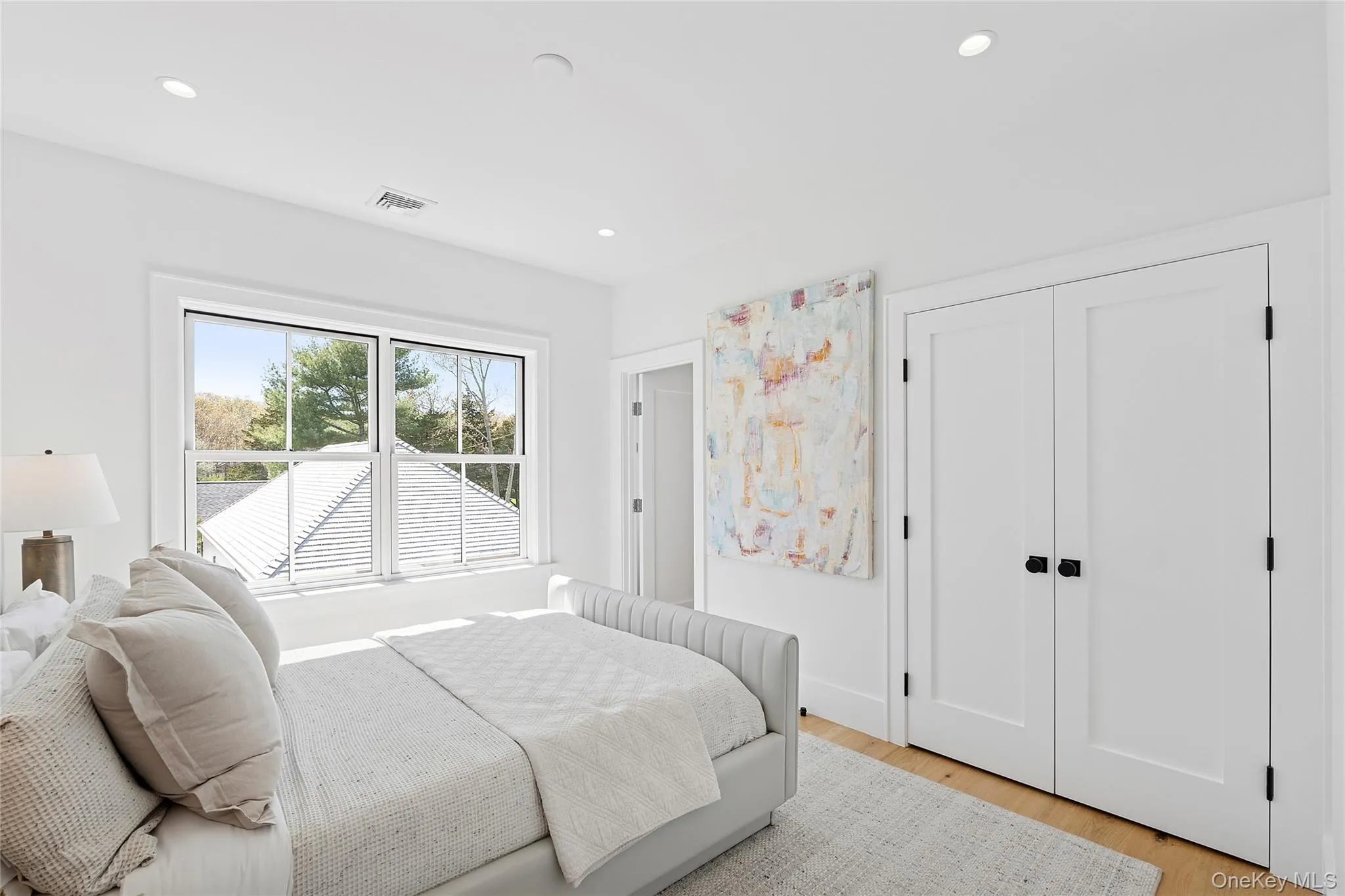 Bedroom featuring light wood-type flooring and recessed lighting Bedroom featuring light wood-type flooring and recessed lighting