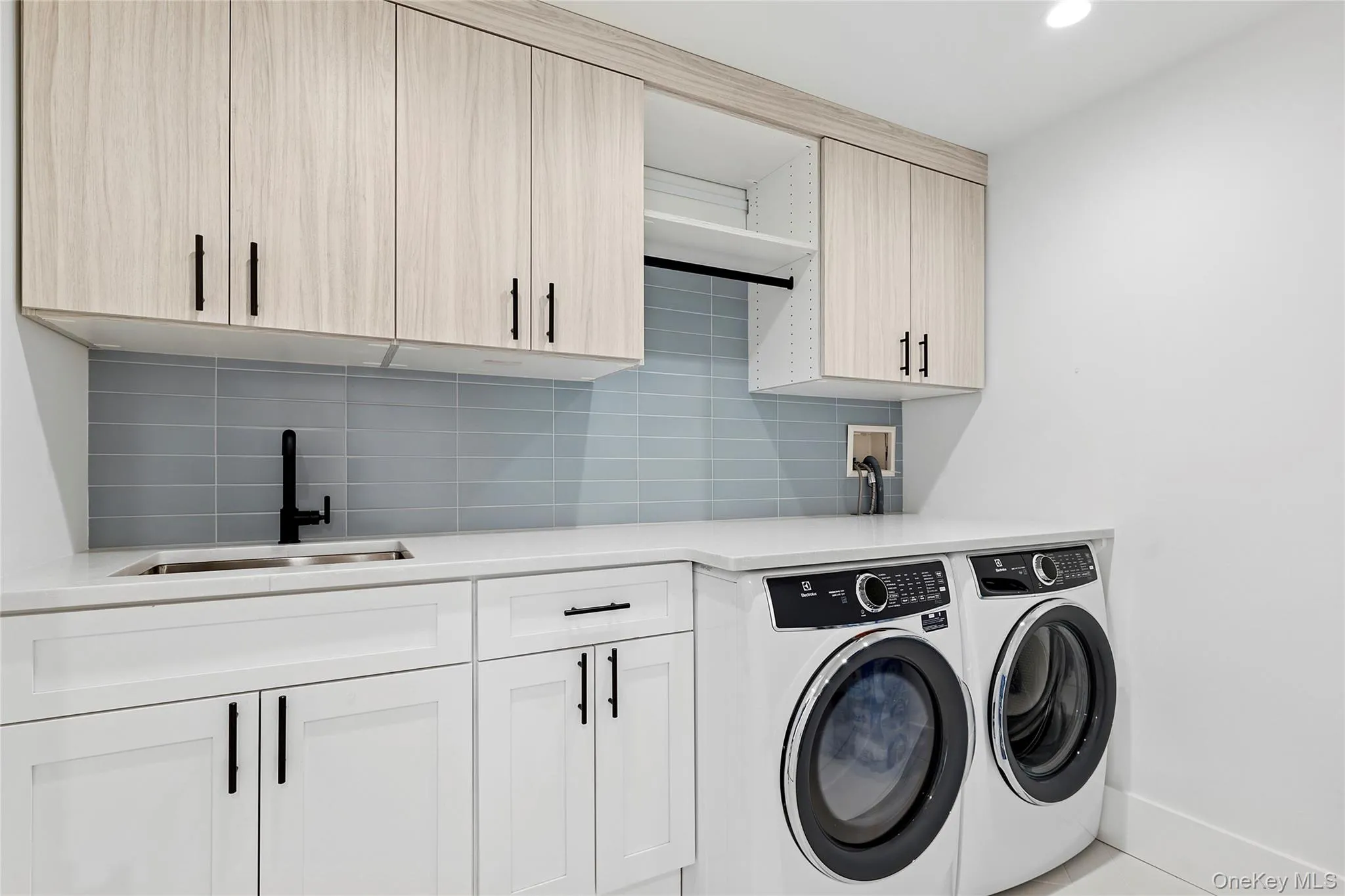 Laundry room with cabinet space, washing machine and clothes dryer, and recessed lighting Laundry room with cabinet space, washing machine and clothes dryer, and recessed lighting